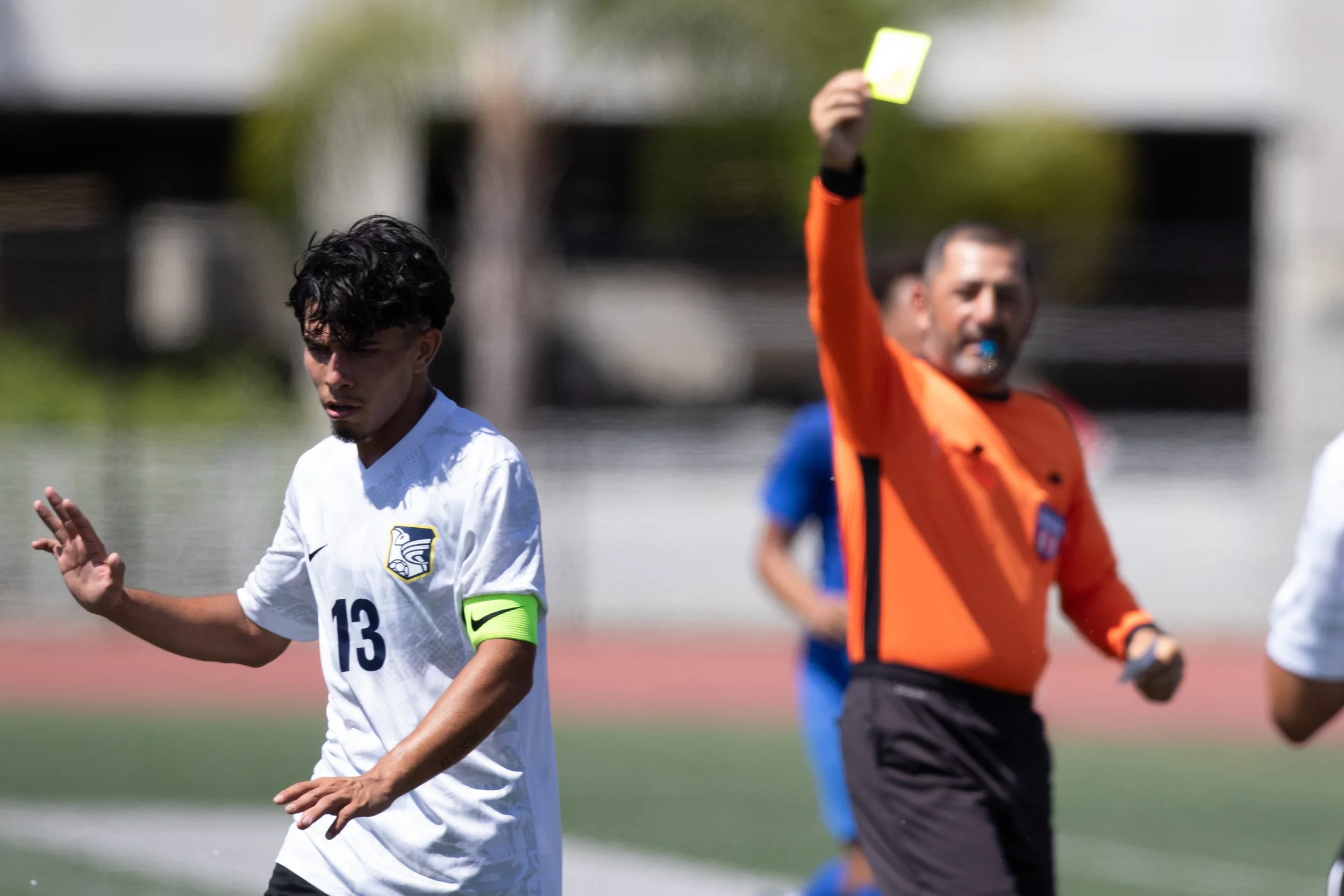  Fullerton College Hornets middle Cisco Torres (#13) dismissing the Referee after receiving a yellow card due to tripping Santa Monica College (SMC) Corsairs middle Leo Blanchet (#20) at SMC Corsair Stadium, Santa Monica, Calif. SMC Corsairs tied wit