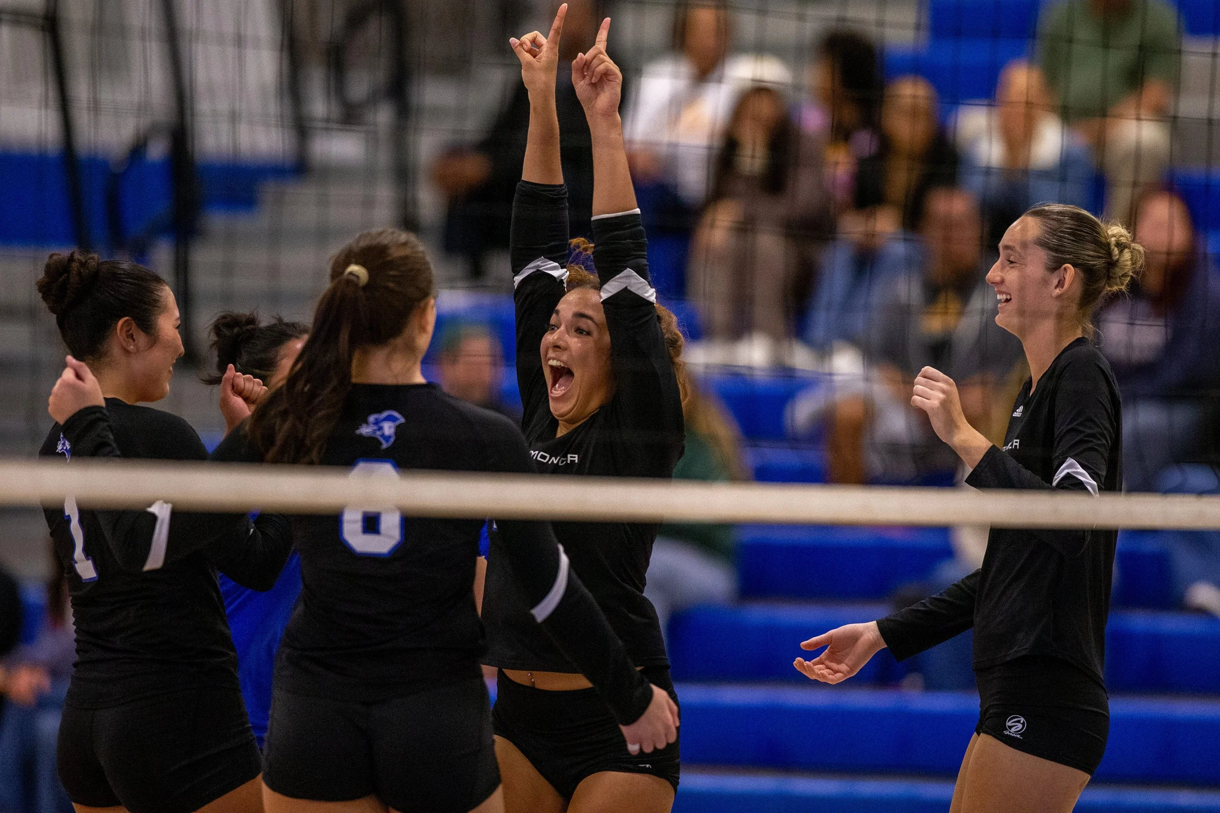  Santa Monica College (SMC) Corsair Middle Blocker / Outside Hitter / Libero Mia Whitlock (#10) celebrates with her teammates after successfully scoring against Pasadena City College (PCC) Lancers during the second round of the California Community C