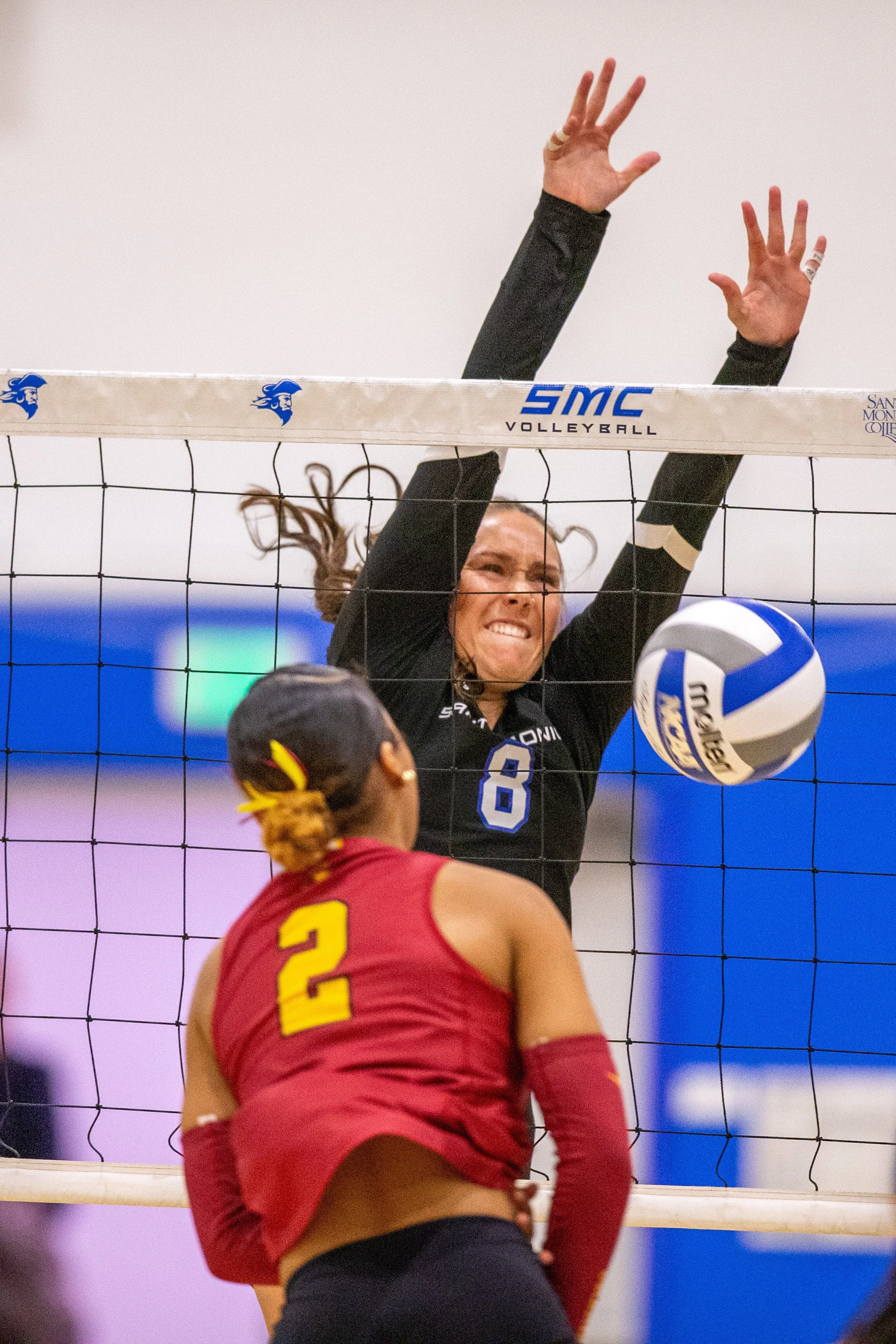  Santa Monica College (SMC) Corsair Outside Hitter/Middle Blocker Reese Luke (#8) attempting to block a shot from Pasadena City College (PCC) Lancer Outside Hitter / Opposite Hitter Payton Scott (#2) during the second round of the California Communit