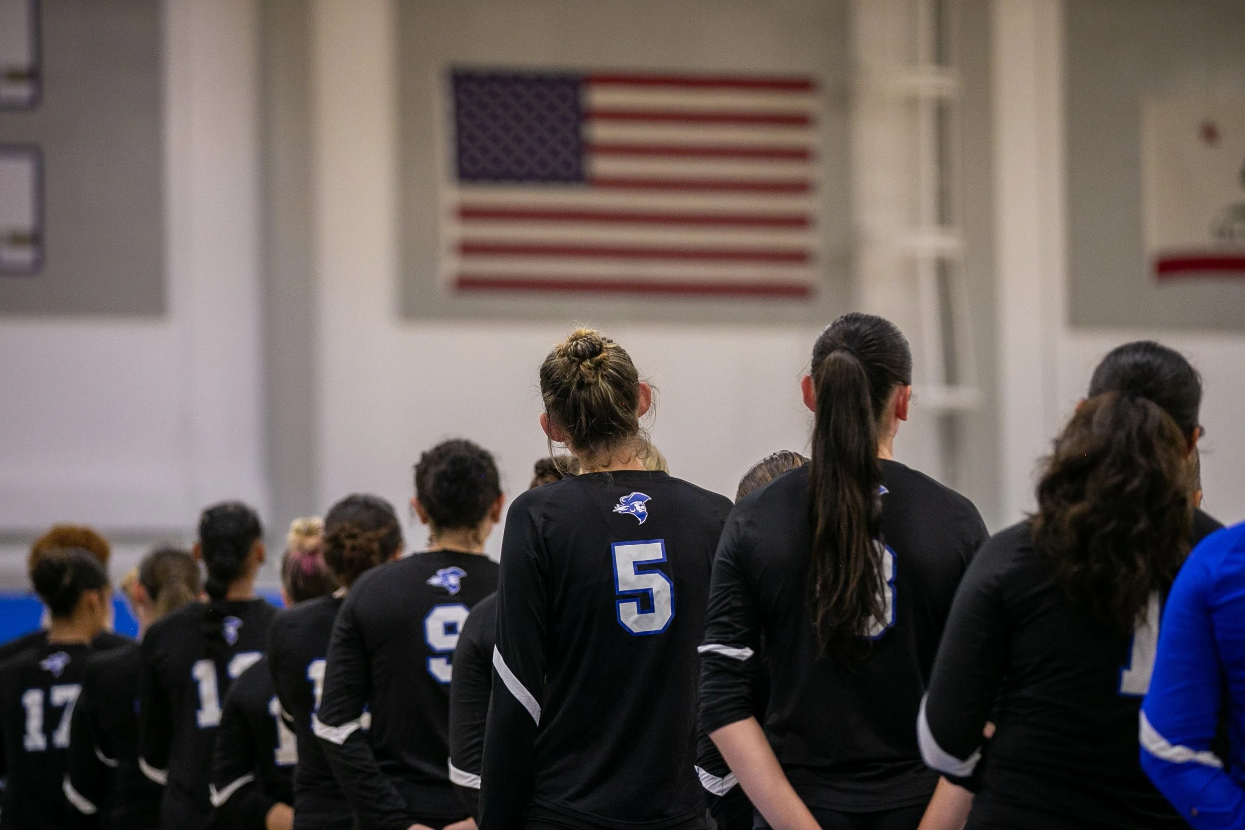  Santa Monica College (SMC) Corsairs women's volleyball team looking towards the U.S. flag while singing the National Anthem before a match against Glendale Vaqueros at SMC Corsair Gym, Santa Monica, Calif., on Sept 26, 2025. The SMC Corsairs won 3-0
