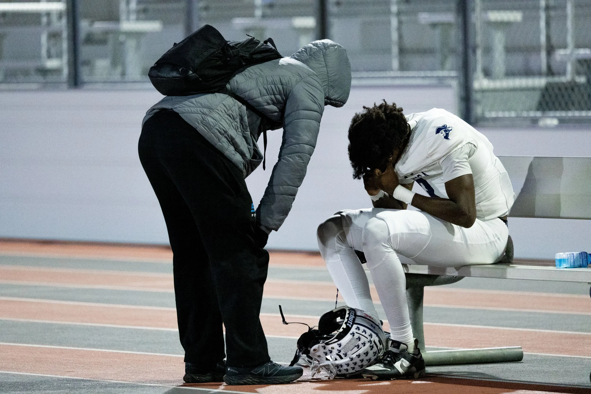  Santa Monica College (SMC) Corsair WR (3) Elijah Aaron buries his face in his hands while being consoled after the SMC Corsairs were defeated 38-22 at the American Division Championship Bowl Game at Victor Valley College in Victorville, Calif., on S