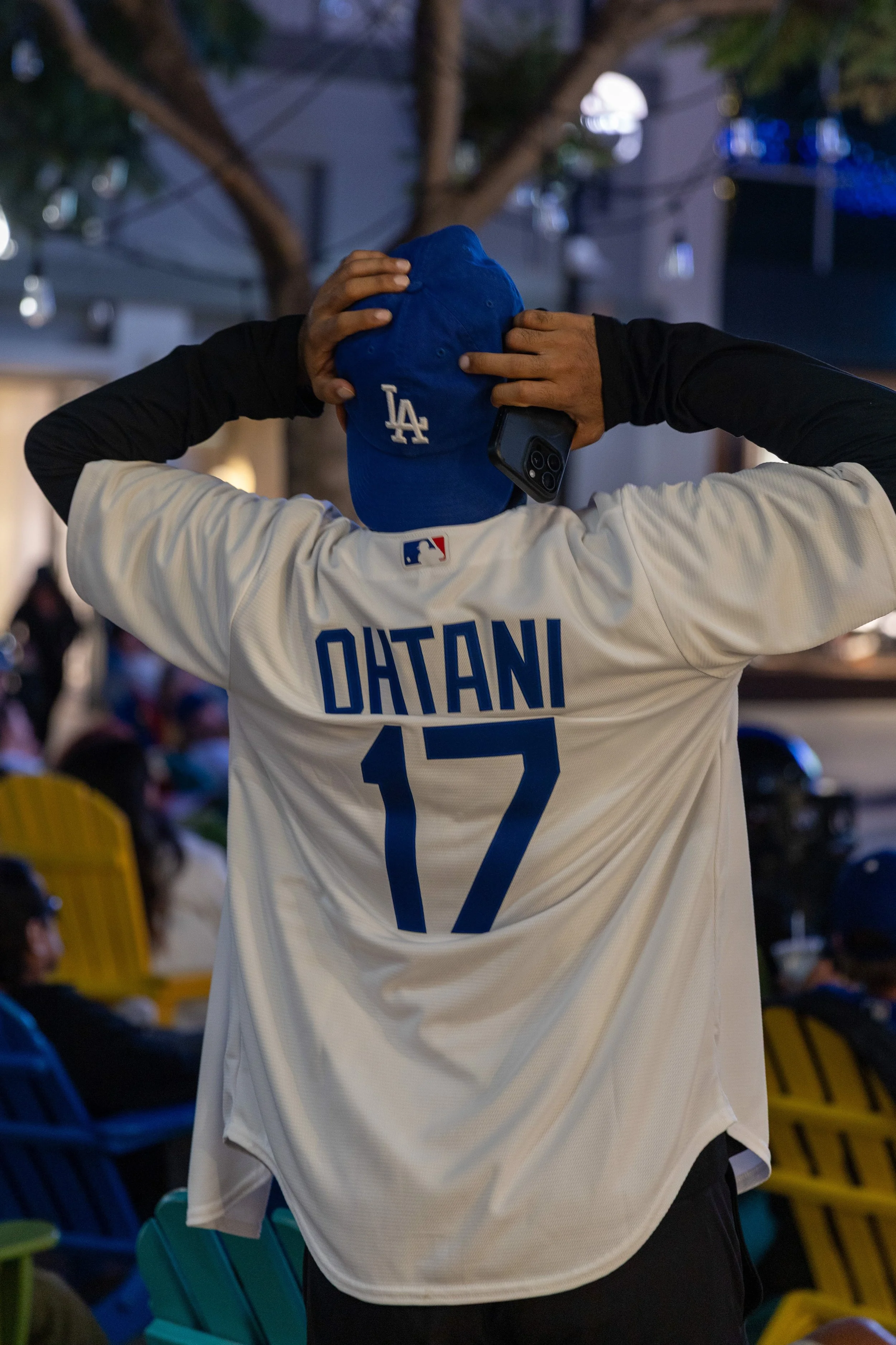 A Los Angeles (LA) Dodger Fan being visibly distressed after Tommy Edman hit a double play and ending the inning during game 5 of the World Series as the Dodgers face off against the Toronto Blue Jays, with fans watching on 3rd Street Promenade, San