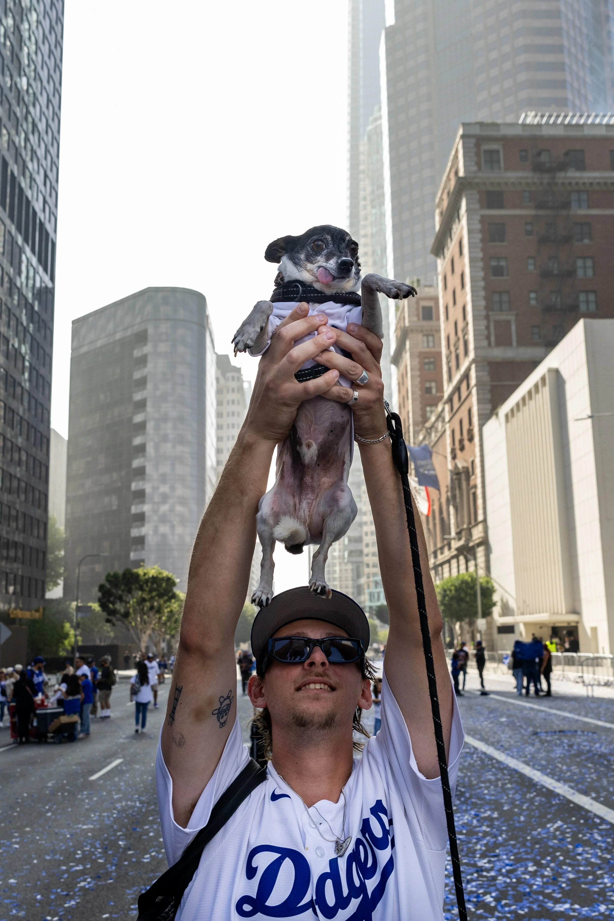  A Los Angeles Dodger fan hoists their pet dog, Bart, above their head after the Dodgers parade on Monday, Nov. 3, 2025, in downtown Los Angeles. Jake Crandall | The Corsair 