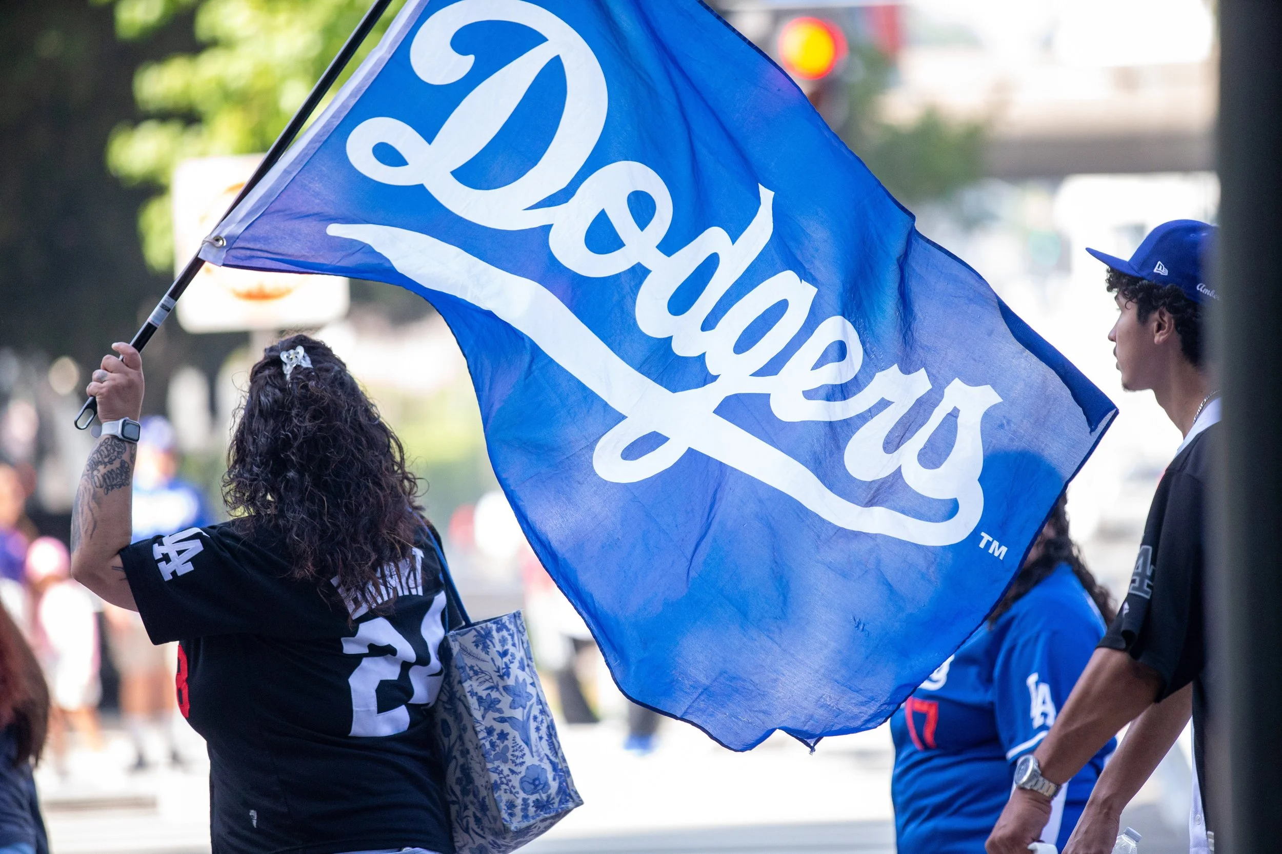  A Los Angeles (LA) Dodgers fan waving a Dodgers flag after the Dodgers World Series Champions Parade at Hope and 3rd, Los Angeles, Calif., on Monday, Nov 3rd, 2025. The LA Dodgers won against the Toronto Blue Jays 4-3 in the seventh game of the Worl