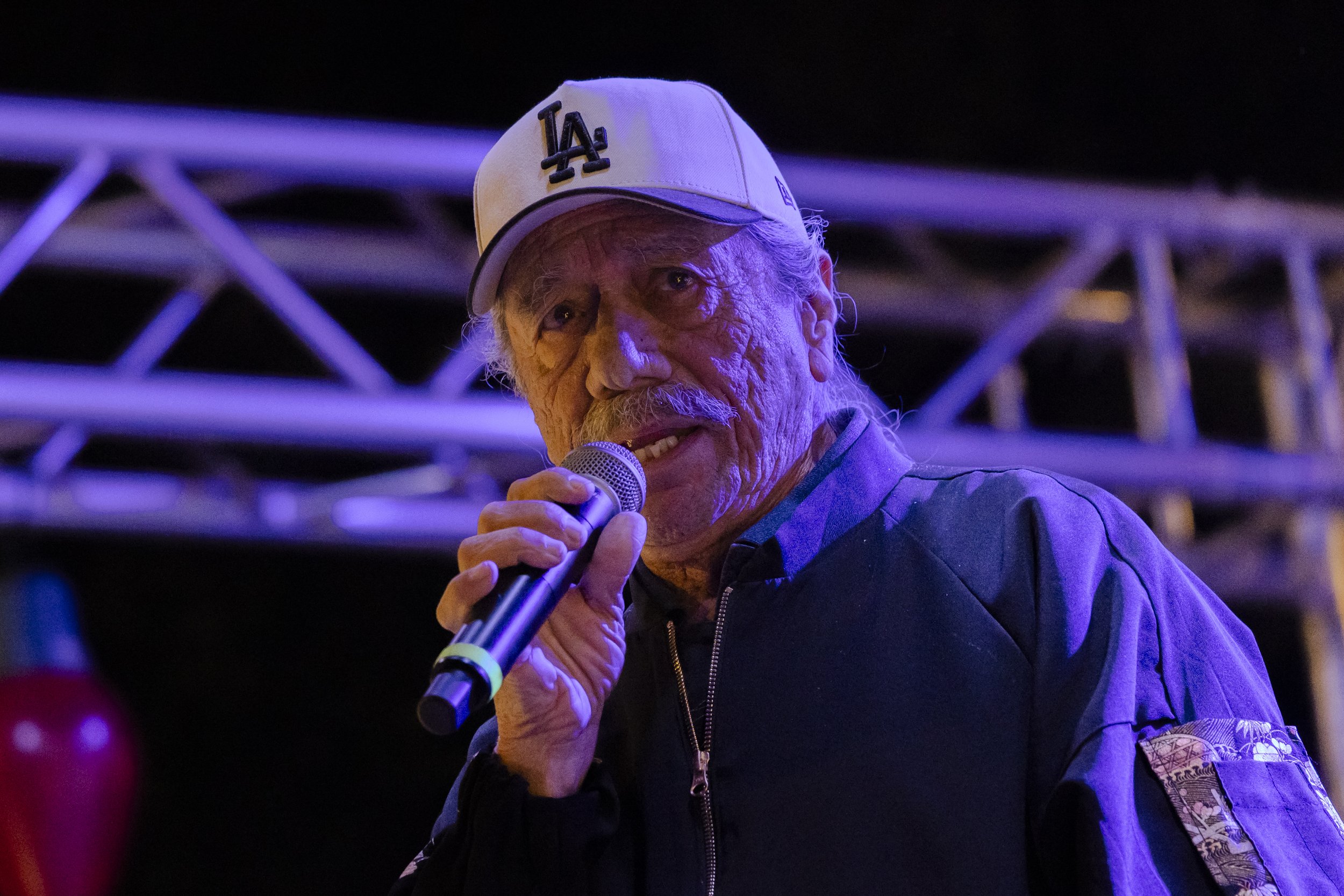  Actor Edward James Olmos speaks to a crowd of thousands who gathered in Altadena, Calif., on Saturday, Dec. 8, 2025, for the 105 Christmas Tree Lane lighting ceremony. A stretch of deodar cedar trees on Santa Rosa Boulevard is decorated with Christm