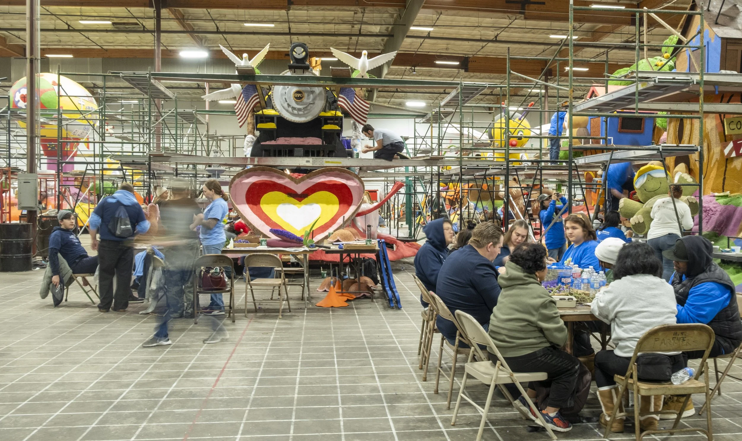  Workers gather in a warehouse in Irwindale, Calif. to decorate Rose Parade floats on Friday, Dec.. 26, 2025. (The Corsair | Fai Fong) 