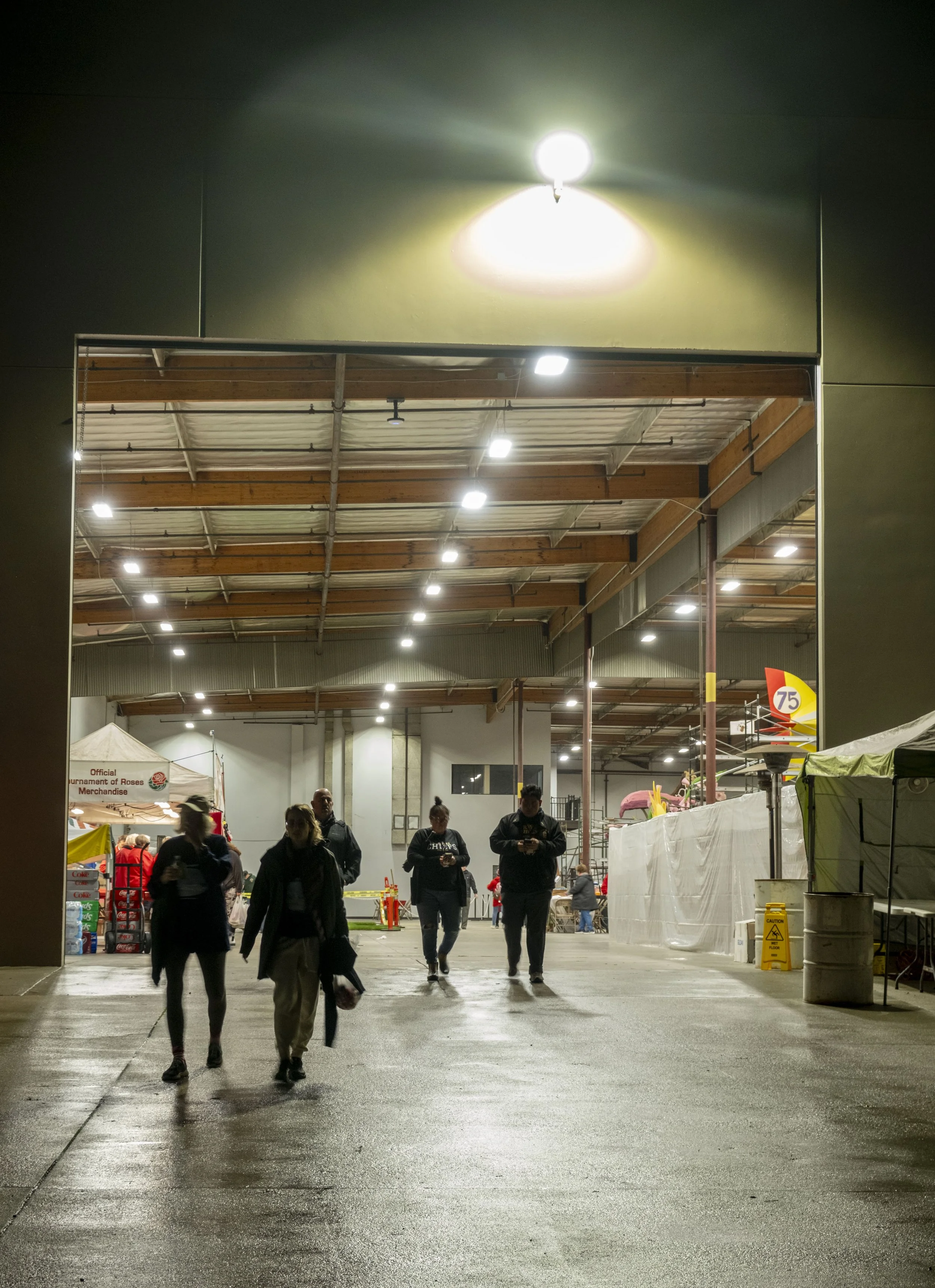  Workers leave for the day after hours of decorating Rose Parade floats on Friday, Dec. 26, 2025 at a warehouse in Irwindale, Calif.  (The Corsair | Fai Fong) 