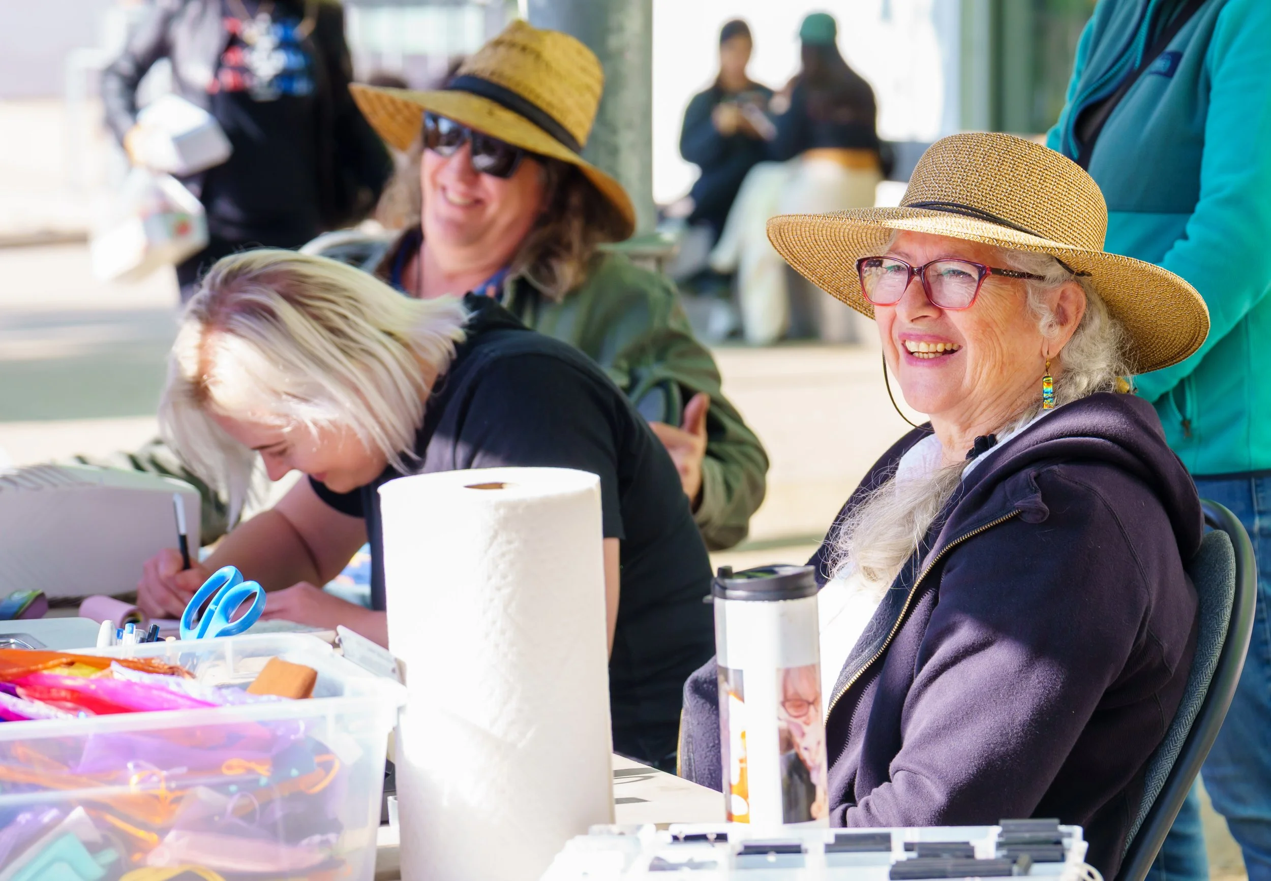  Santa Monica College (SMC) Associate Professor Terri Bromberg (R) at the checkout table with Eden Hayer (middle) and Darren Frale (L) during SMC's Valentine’s Day Glass Sale at Virginia Park Farmers Market in Santa Monica, Calif., Saturday, Feb. 7, 