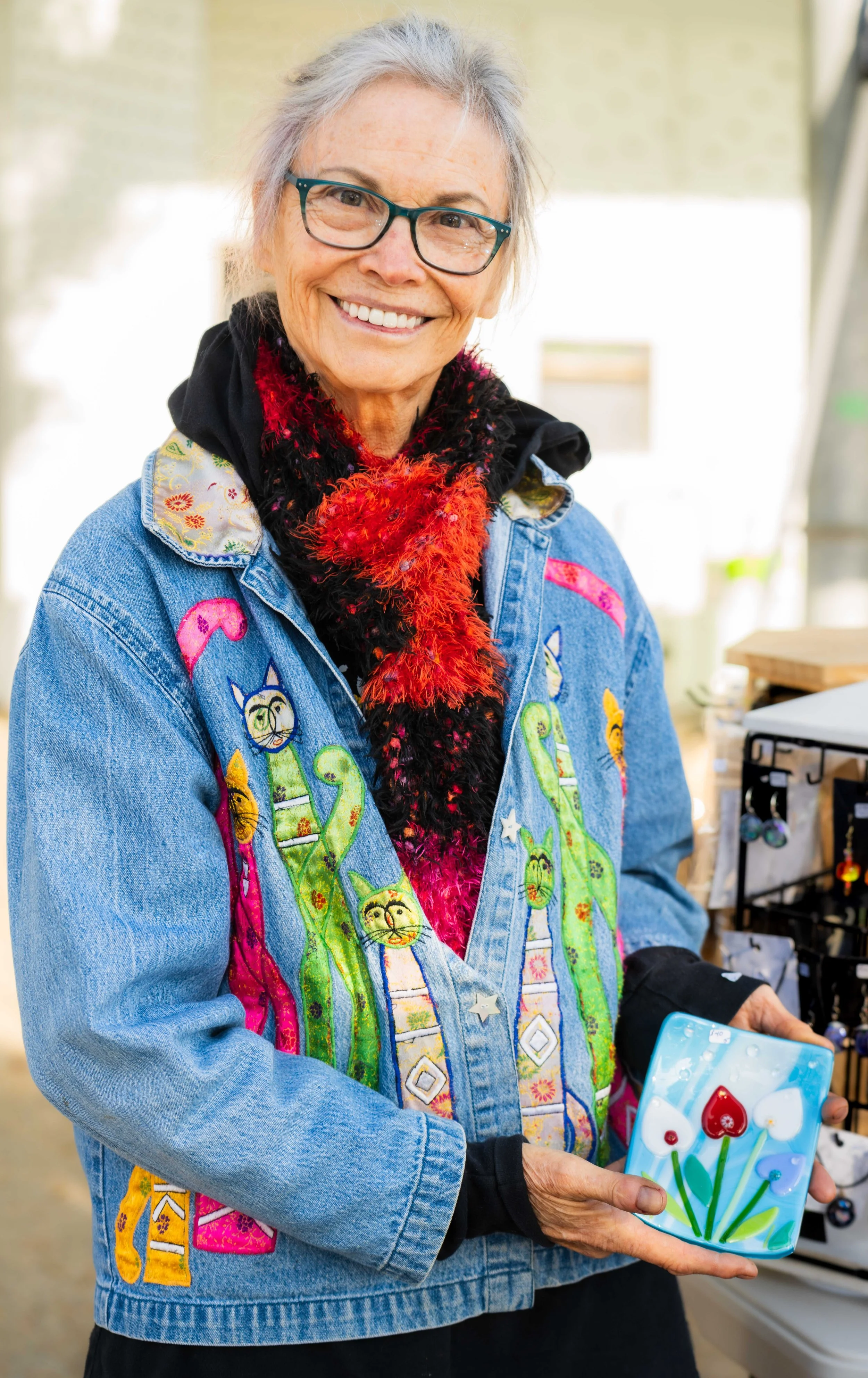  Santa Monica College (SMC) Community Education glass fusing artist Denise Bachman holds one of her pieces during the SMC Valentine’s Day Glass Sale at the Virginia Park Farmers Market in Santa Monica, Calif., Saturday, Feb. 7, 2026. The sale feature