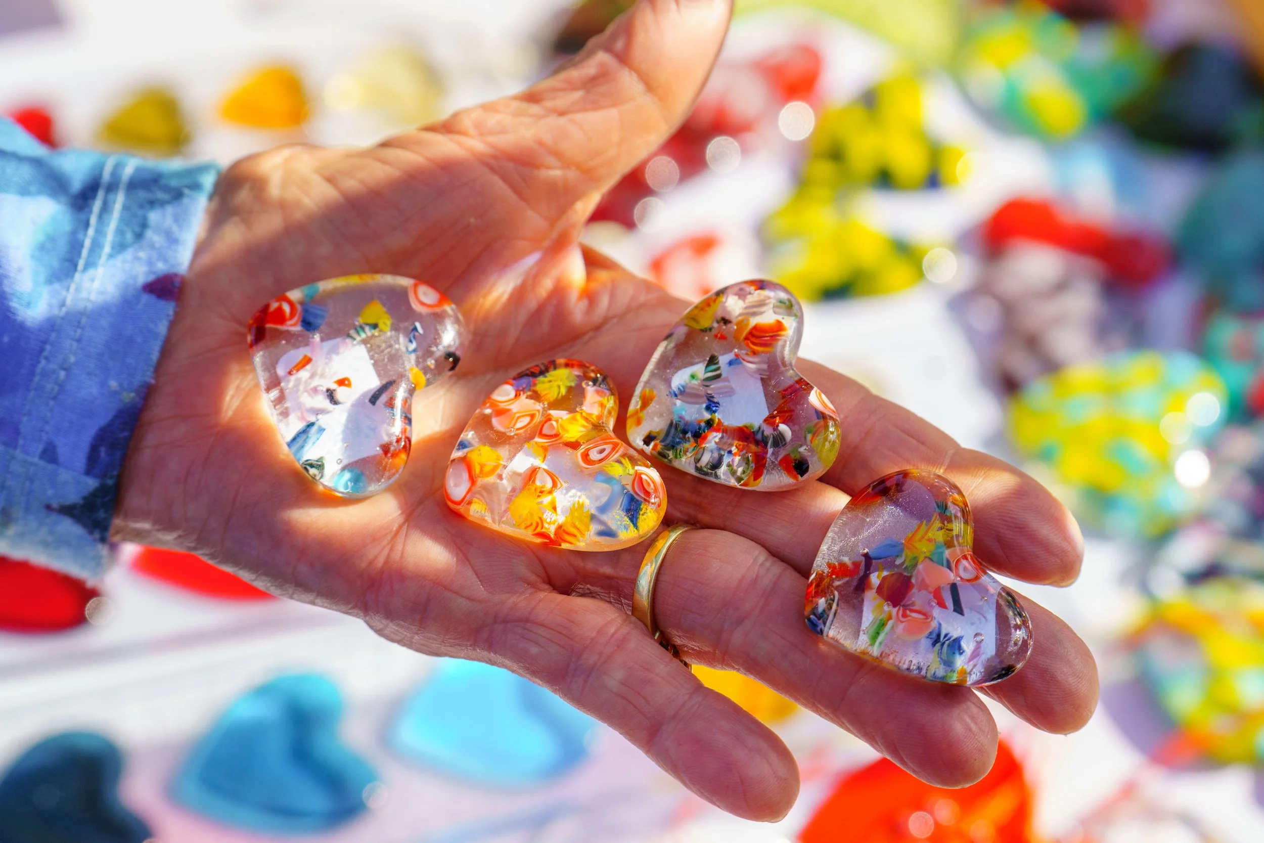  Laurie Gillis holds glass hearts made by Santa Monica College (SMC) Community Education glass fusing artist Janet Zander during SMC's Valentine’s Day Glass Sale at the Virginia Park Farmers Market in Santa Monica, Calif., Saturday, Feb. 7, 2026. Gil