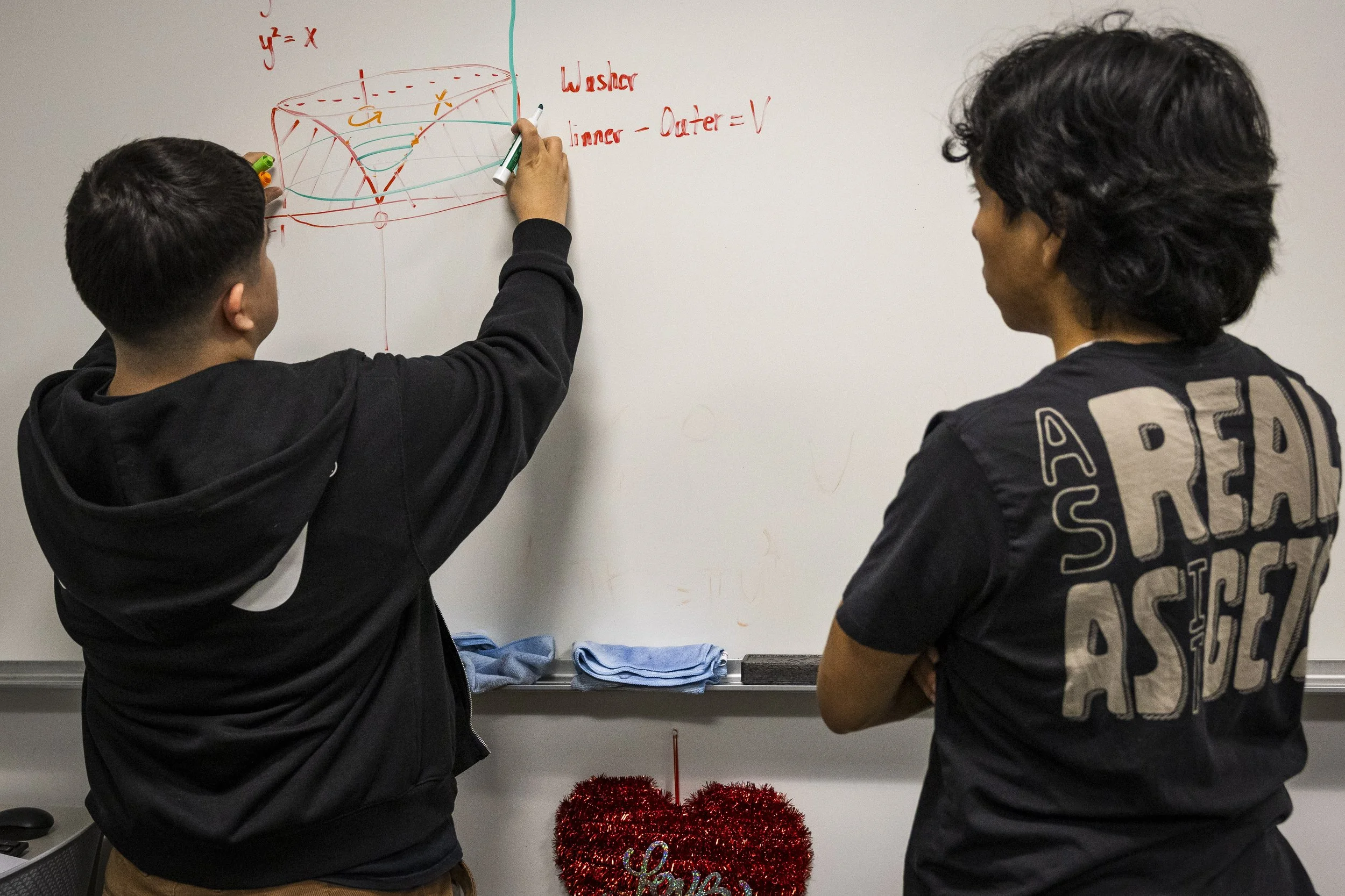  Daniel Rocha (Left) and Orlando Fernandez (Right) solve a Calculus 1 equation inside the Student Services Center at Santa Monica College in Santa Monica, Calif., on Monday, February 9, 2026, during Rocha’s tutoring availability in preparation for wi