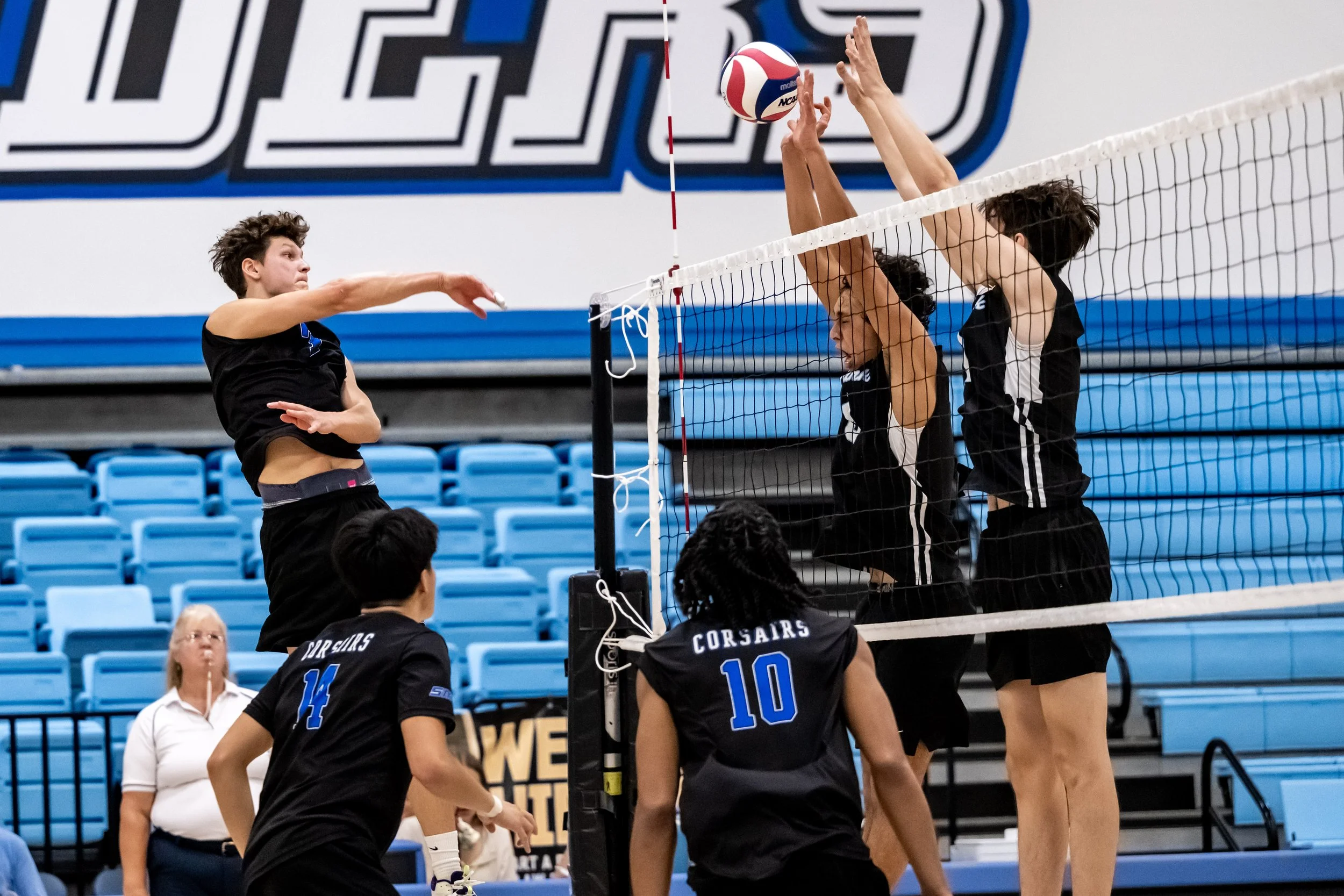  Santa Monica College Corsair Demian Anisimov (7) spikes the ball past the Moorpark City College Raiders defense during their match in Moorpark, Calif., on Friday, Feb. 27, 2026. The Corsairs won the match 3 sets to 1. (Tom Rosholt | The Corsair) 