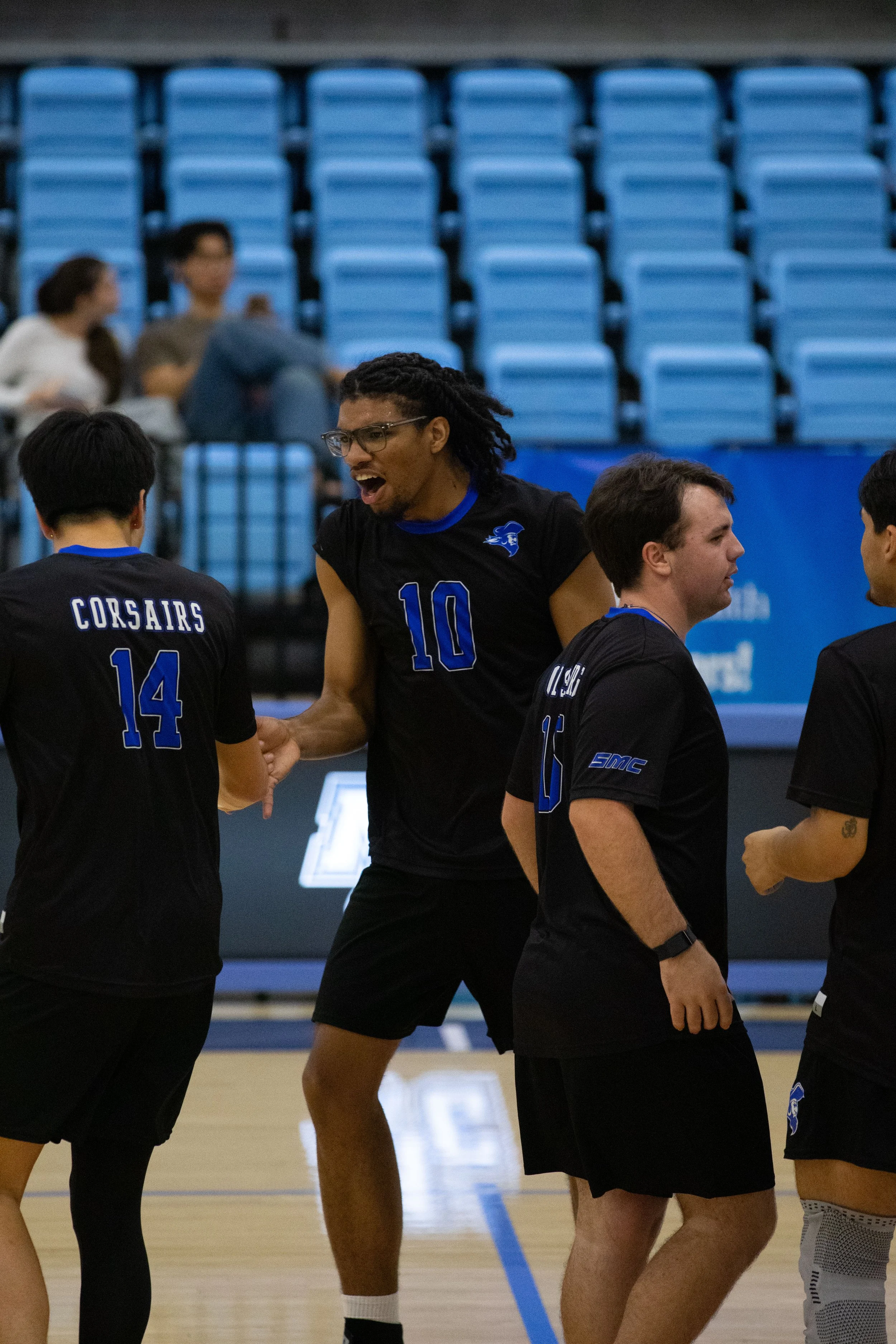  Santa Monica College’s Jayden Lyons (10) (center) celebrates with Ethan Lo (14) (left) and Sean Wahlig (15) (right) after scoring a point during a men’s volleyball match at Moorpark College in Moorpark, Calif., Friday, Feb. 27, 2026. The Corsairs co