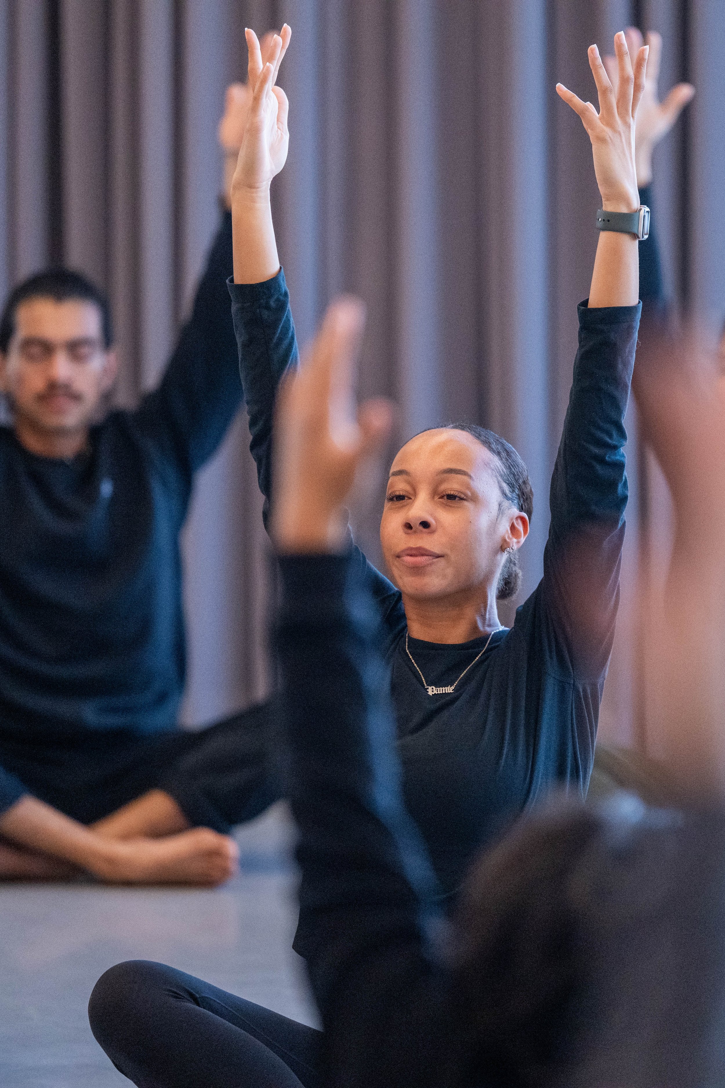  Guest instructor Naomi Hutchinson (R) guides students through a seated stretch during "Dancing Well: Embodying Wellness Through Movement and Mindfulness," a Santa Monica College (SMC) Masters of Dance workshop held at SMC's Core Performance Center i