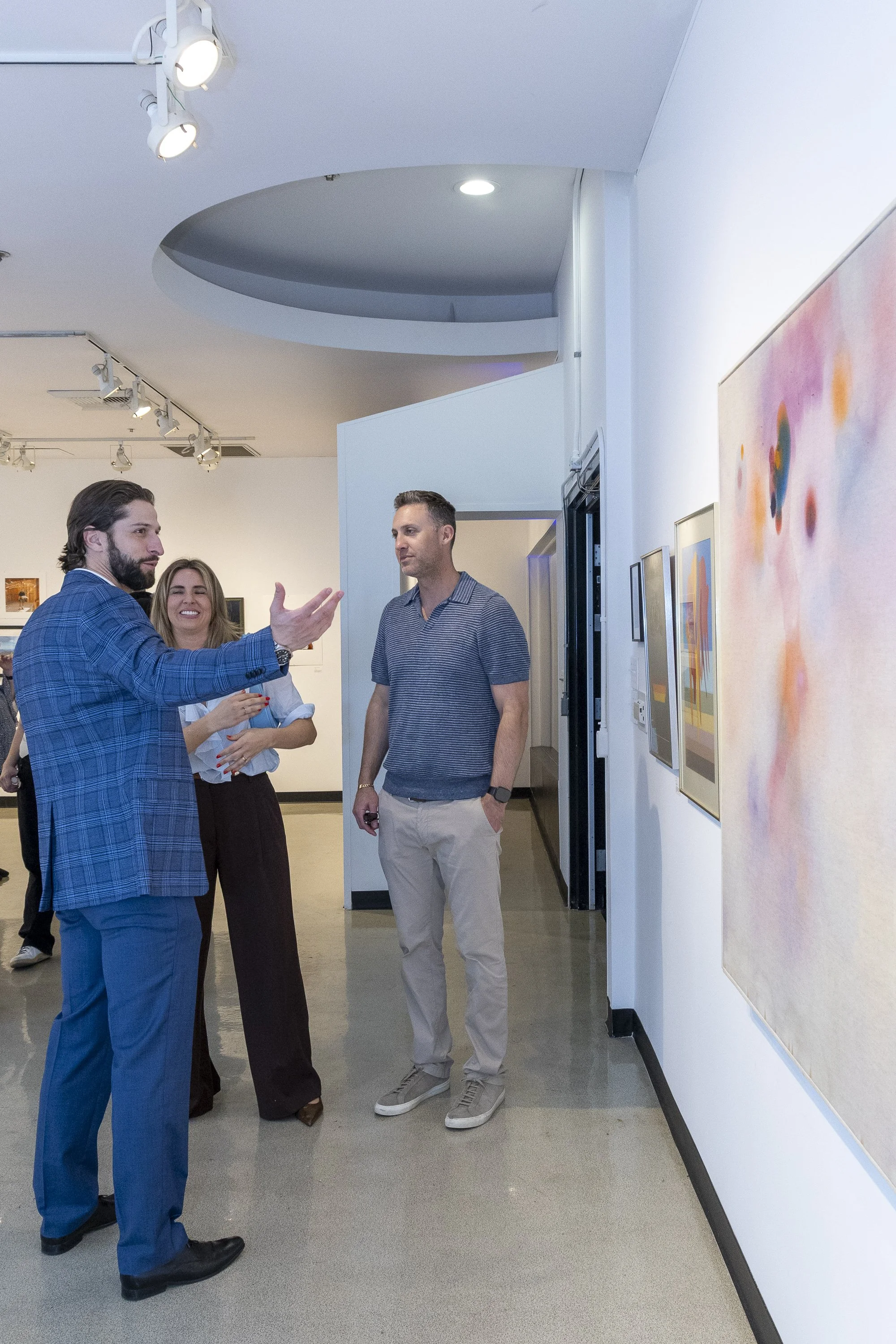  Easton Fier (R), the youngest son of Blue Fier, shares information and memories with gallery visitors during the Opening Night of the Blue Fier – Celebration of Life Exhibit in the SMC Photography Gallery at Drescher Hall, 2nd Floor, on Saturday, Fe