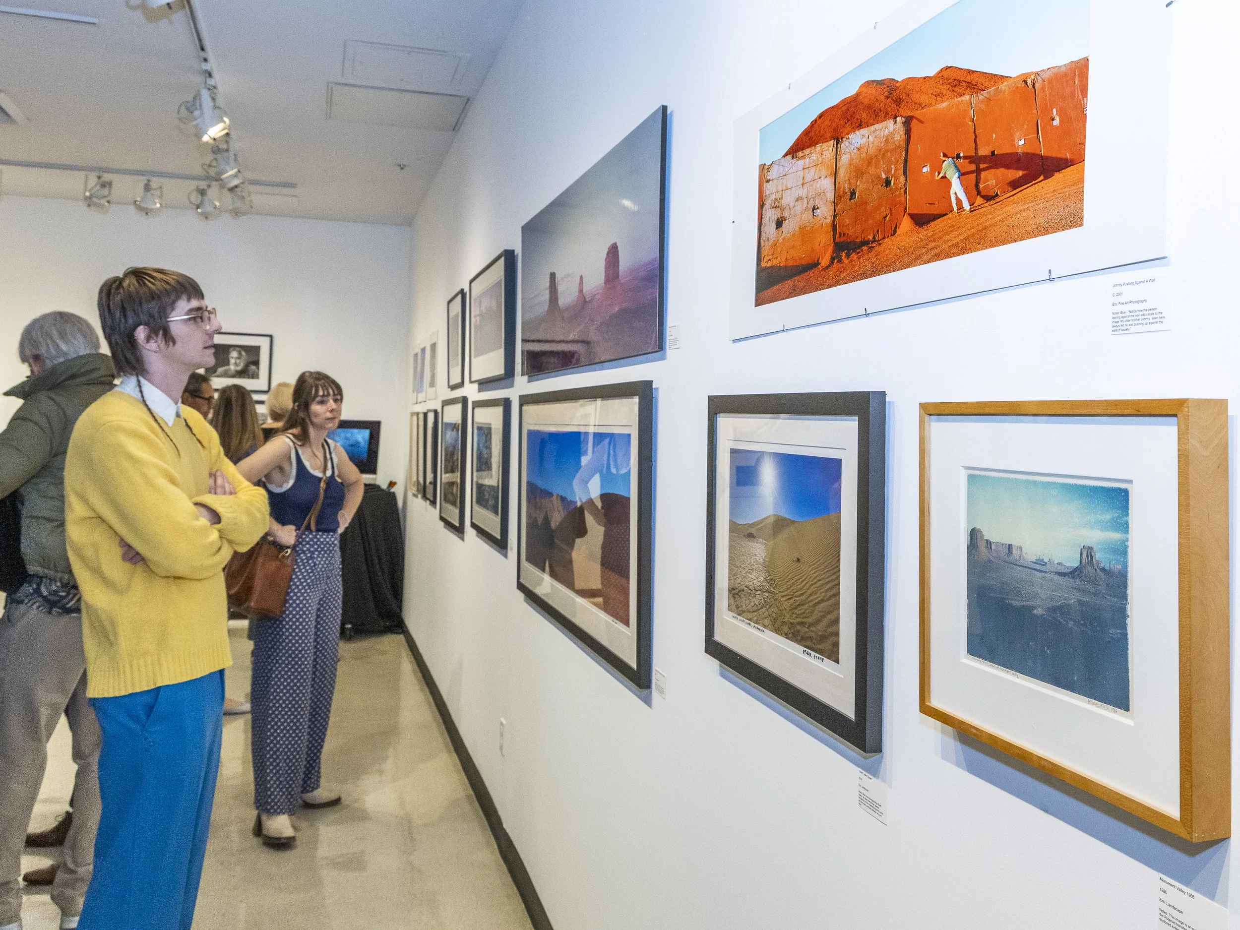  Julian (L) and Cassidy Rawlinson (R), friends of Blue Fier’s wife Kim Saunders looking at Blue Fier’s Panorama and Landscape prints during the Opening Night of the Blue Fier – Celebration of Life Exhibit in the SMC Photography Gallery at Drescher Ha