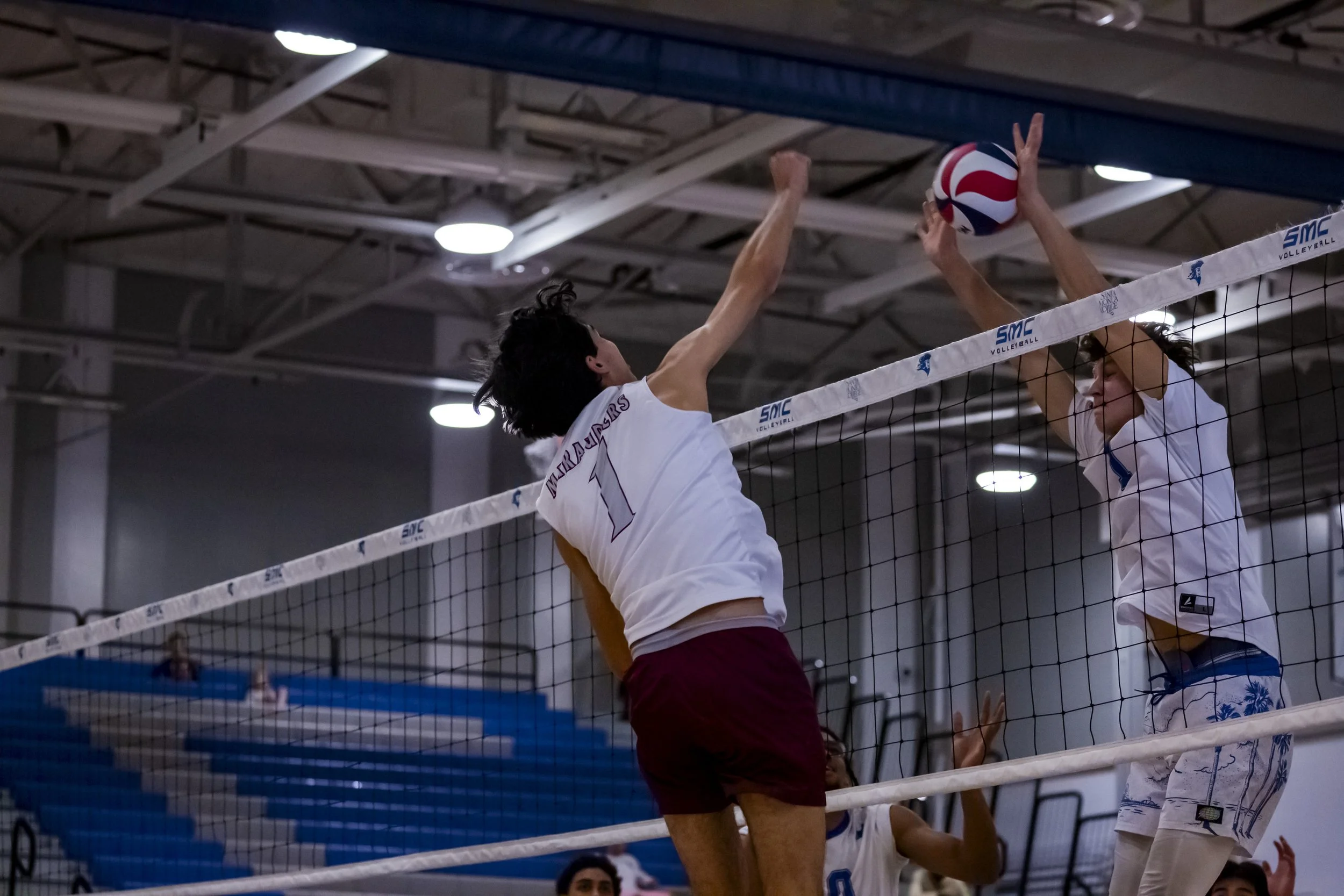  Antelope Valley College (AVC) Marauder Diego Ramirez (AVC) (#1) spikes the ball against a block by Santa Monica College (SMC) Corsair Demian Anisimov (SMC) (#7) during a men’s volleyball match on Fri, March 6, 2026, at Corsair Gym in Santa Monica, C