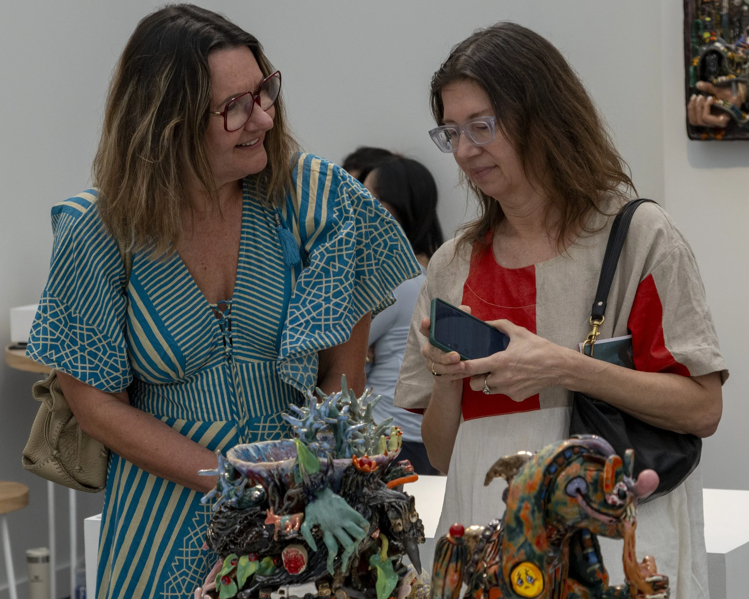  Tina Wolfson (cq) (left) and Catherine Geanuralos (cq) (right) contemplate purchasing a ceramic sculpture by artist and Santa Monica College alum Sharif Farrag (cq) at the Frieze Los Angeles art fair in Santa Monica, Calif., Friday, Feb. 27, 2026. F