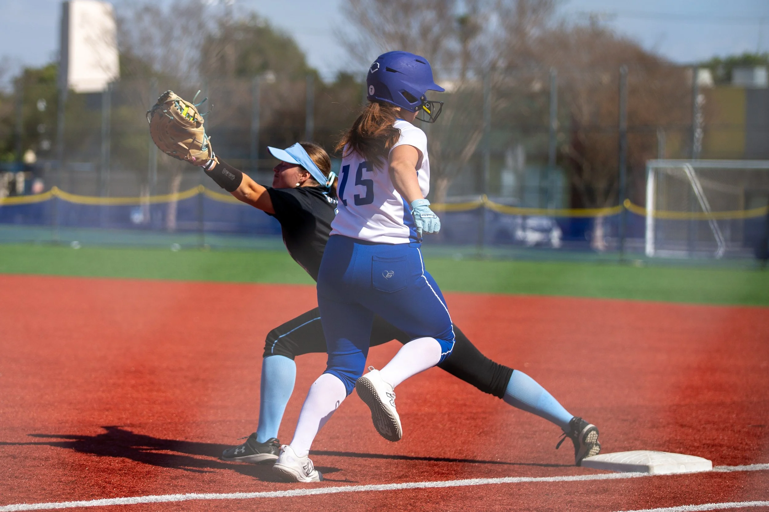  Santa Monica College (SMC) Corsair catcher/infielder Meredian Cordova (#15) gets out from Moorpark College Raiders first baseman Kailey Greene (#14) (CQ) during a match at John Adams Middle School Softball Field, Santa Monica, on Wednesday, March 10