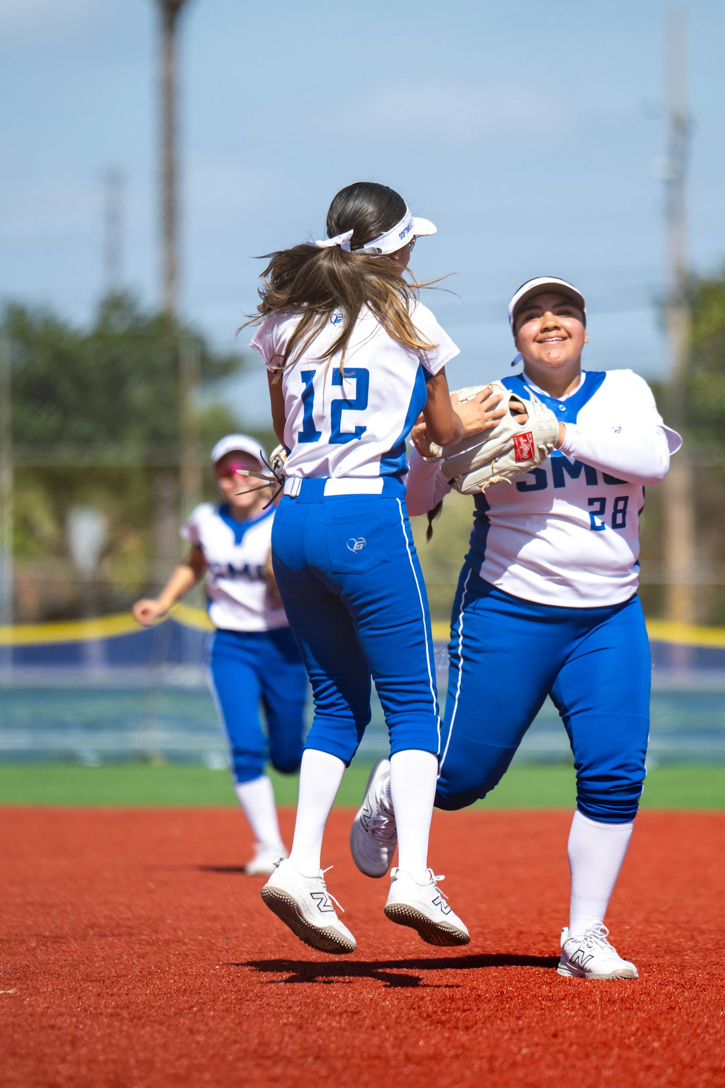  Santa Monica College (SMC) Corsairs (L) second baseman Danaly Santos (12) and third baseman Katrina Olmedo (28) celebrate after a double play during the game against Moorpark College Raiders in Santa Monica, Calif., on Friday, Feb. 27, 2026. The Cor