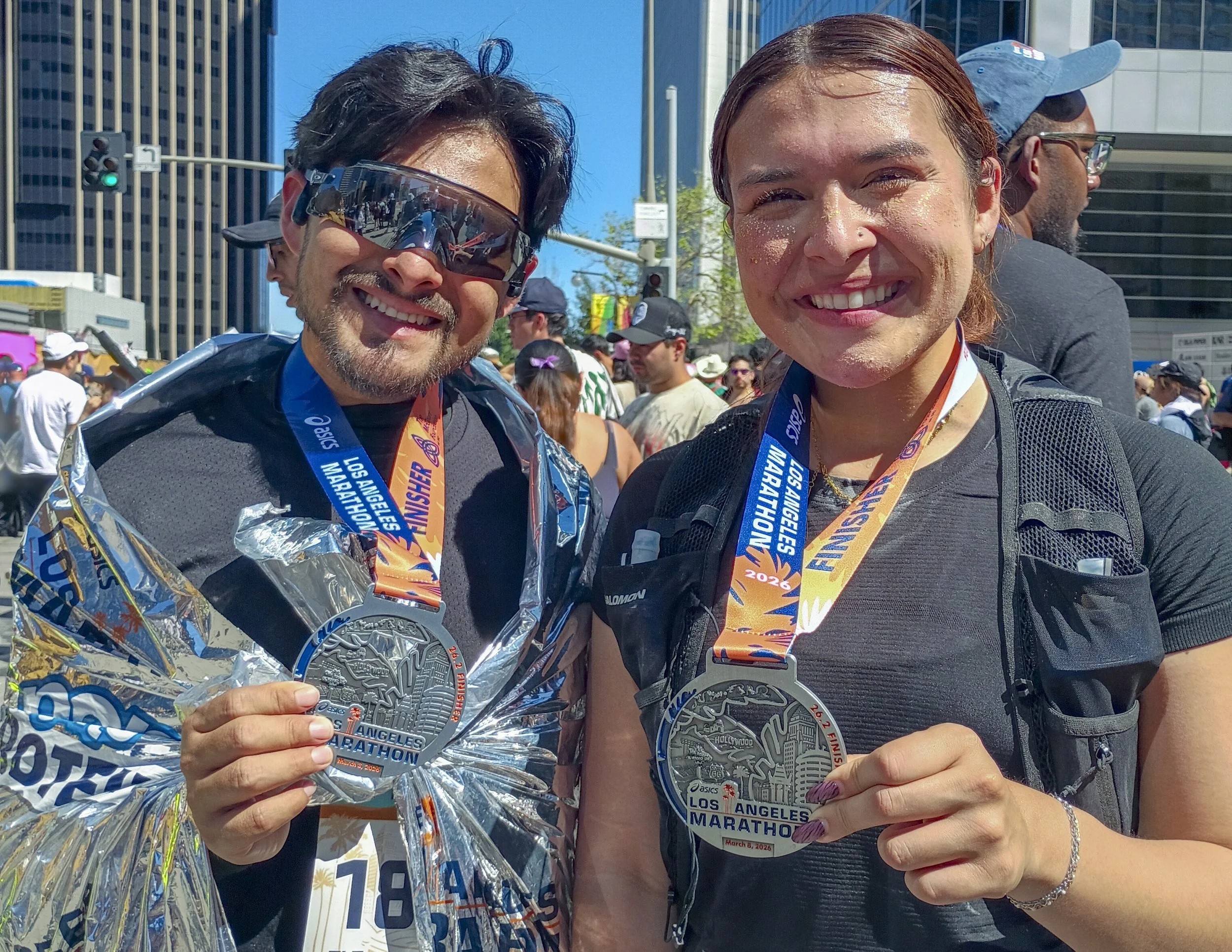  Los Angeles Marathon runners and third year veterans (L-R) Juan Avila & Clarissa Kinder middle school teachers from central valley show off their medals moments after crossing the finish line at the 41st annual LA Marathon on Santa Monica Blvd in Ce