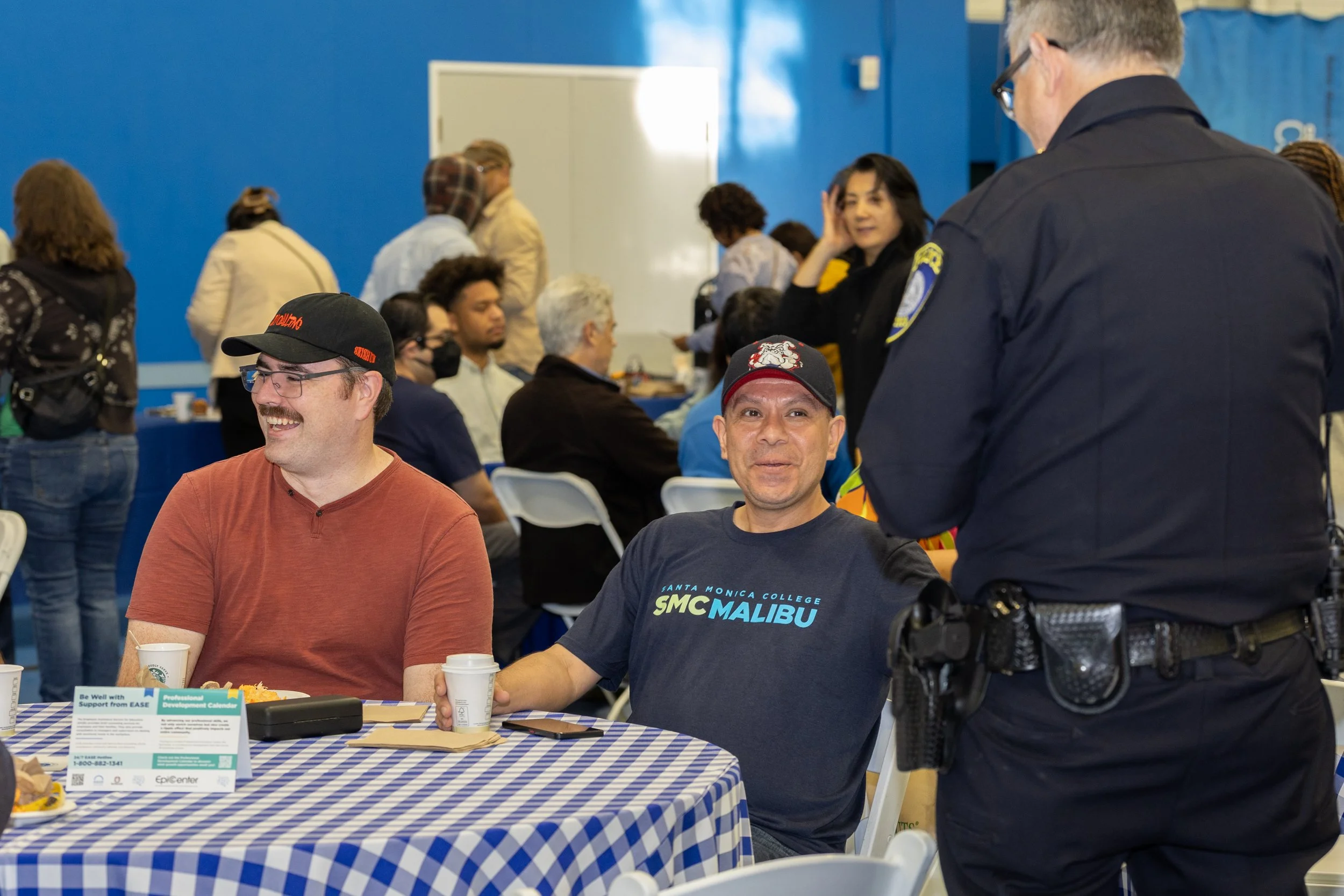  (L-R) Santa Monica College (SMC) Campus Safety officers, Michael Mccann (cq) and Arturo Garcia, speak with Chief of Police Johnnie Adams (cq) before the opening session of SMC Spring 2026 Professional Development Day, which has the theme “Rooted in 