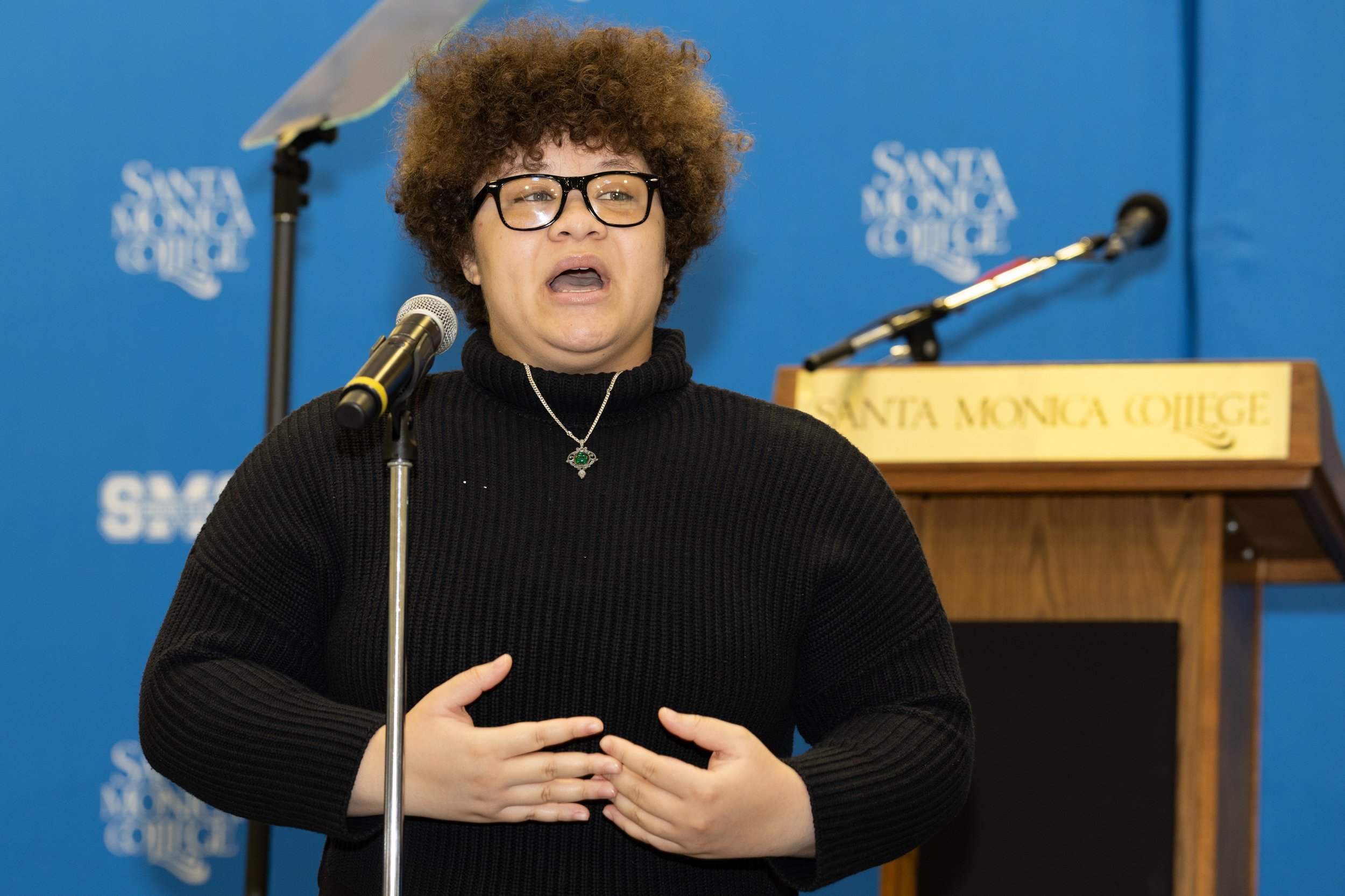  The President of Santa Monica College's  (SMC) Melanated Roots Student Choir, is introducing the choir’s performance during the SMC Spring 2026 Professional Development Day during the Opening Session on Tuesday, March 17, 2026 at the SMC Pavillion (