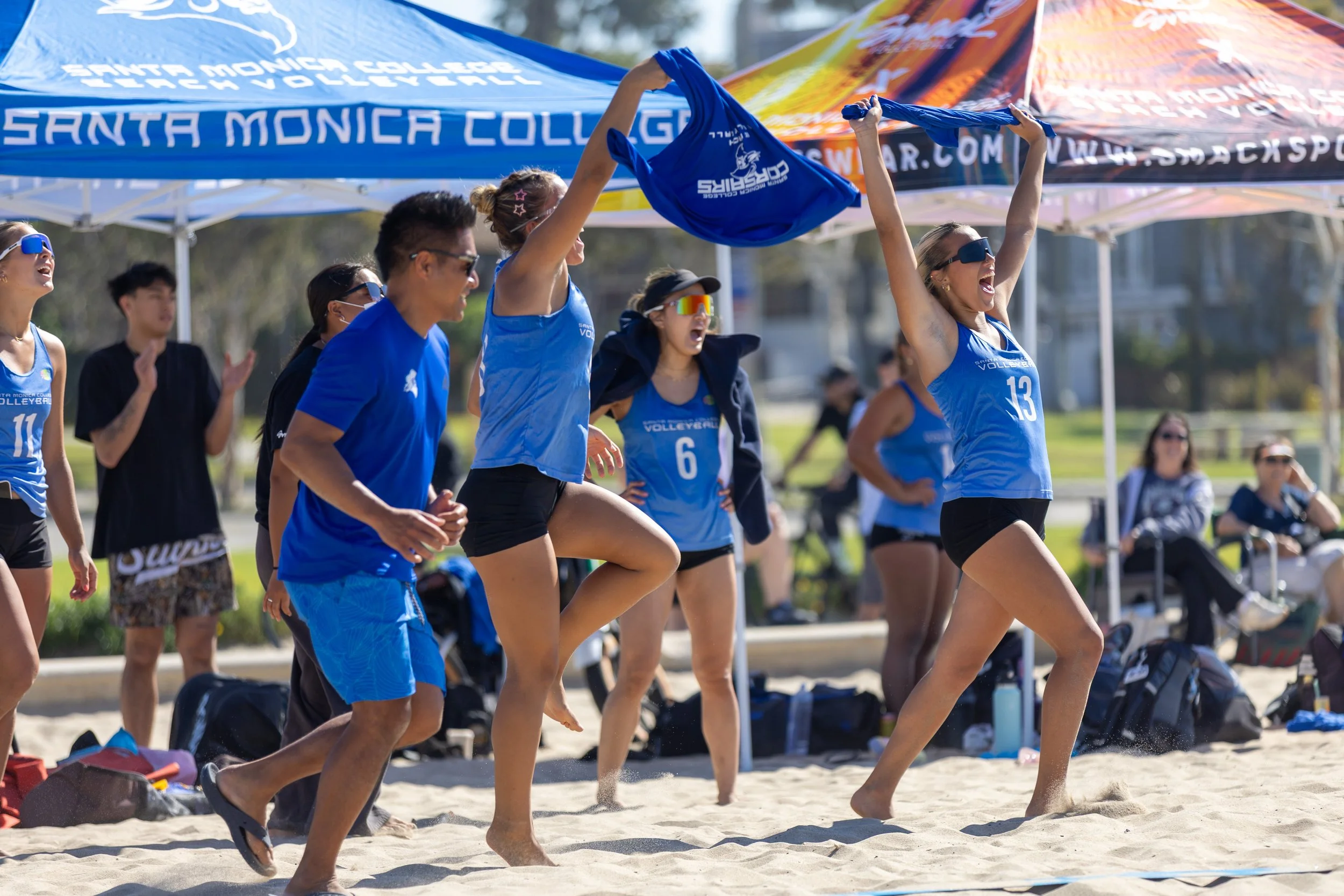  Santa Monica College (SMC) Corsair players and coaches are celebrating after their teammates won their game against a pair of Cypress College Chargers players during a non-conference game, at Ocean Park North Beach Volleyball Courts, Santa Monica, C