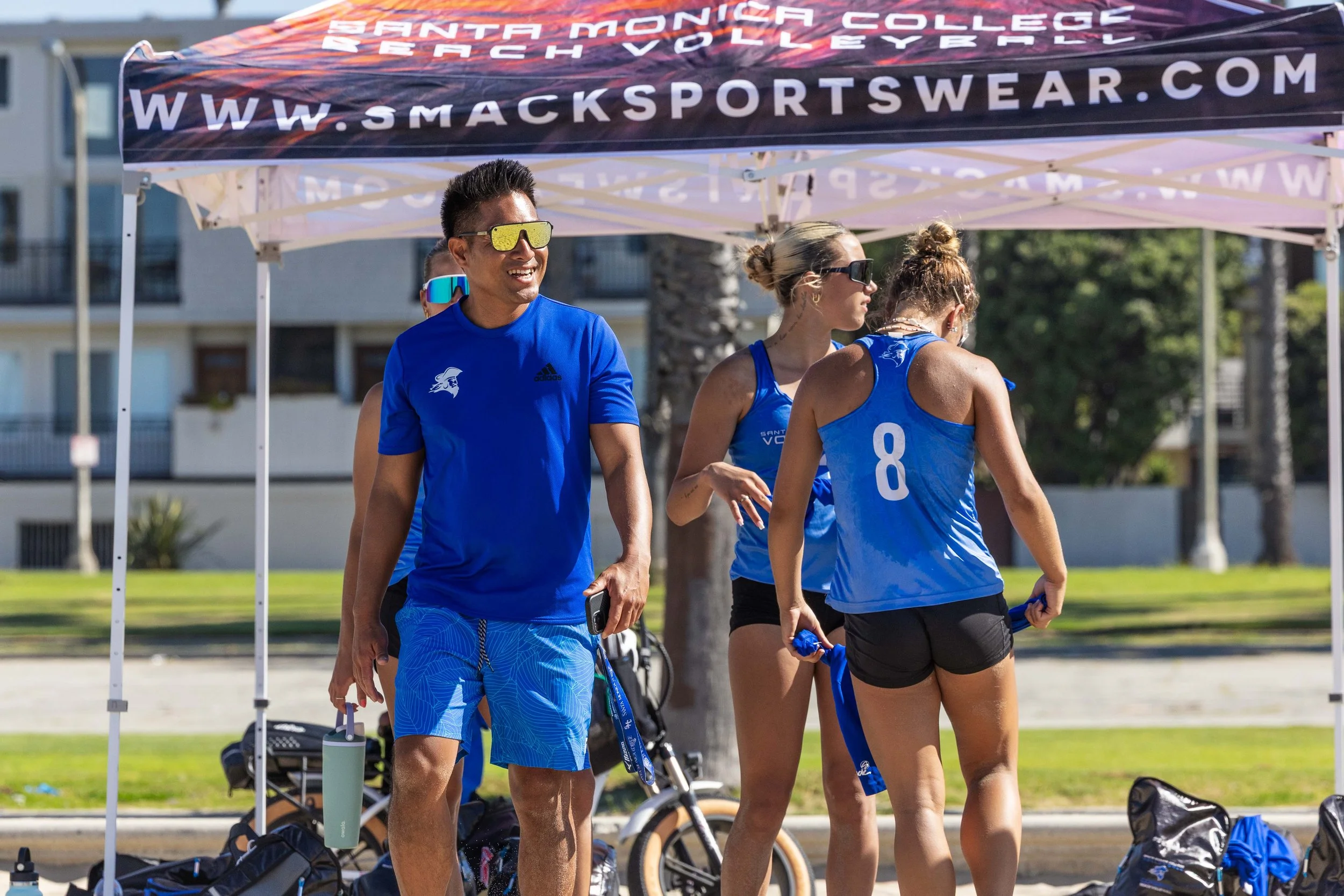  Santa Monica College women's volleyball coach Christian Cammayo (L) during the Corsairs' last game of the morning against the Cypress College Chargers at Ocean Park North Beach Volleyball Courts in Santa Monica, Calif., Wednesday, March 18, 2026. Th