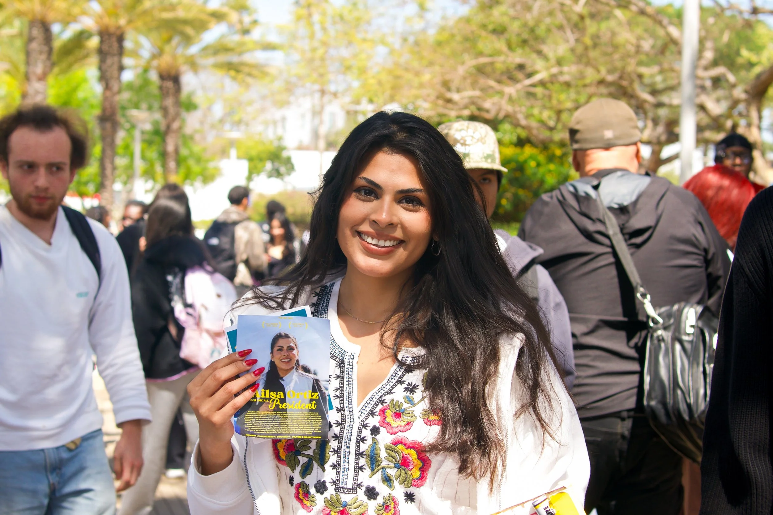  Ailsa Ortiz, a political science major and vice president of the Indigenous Scholars Club, stands with a flyer to help boost awareness of her candidacy for Associated Students president on the Santa Monica College campus on Tuesday, March 25, 2025, 