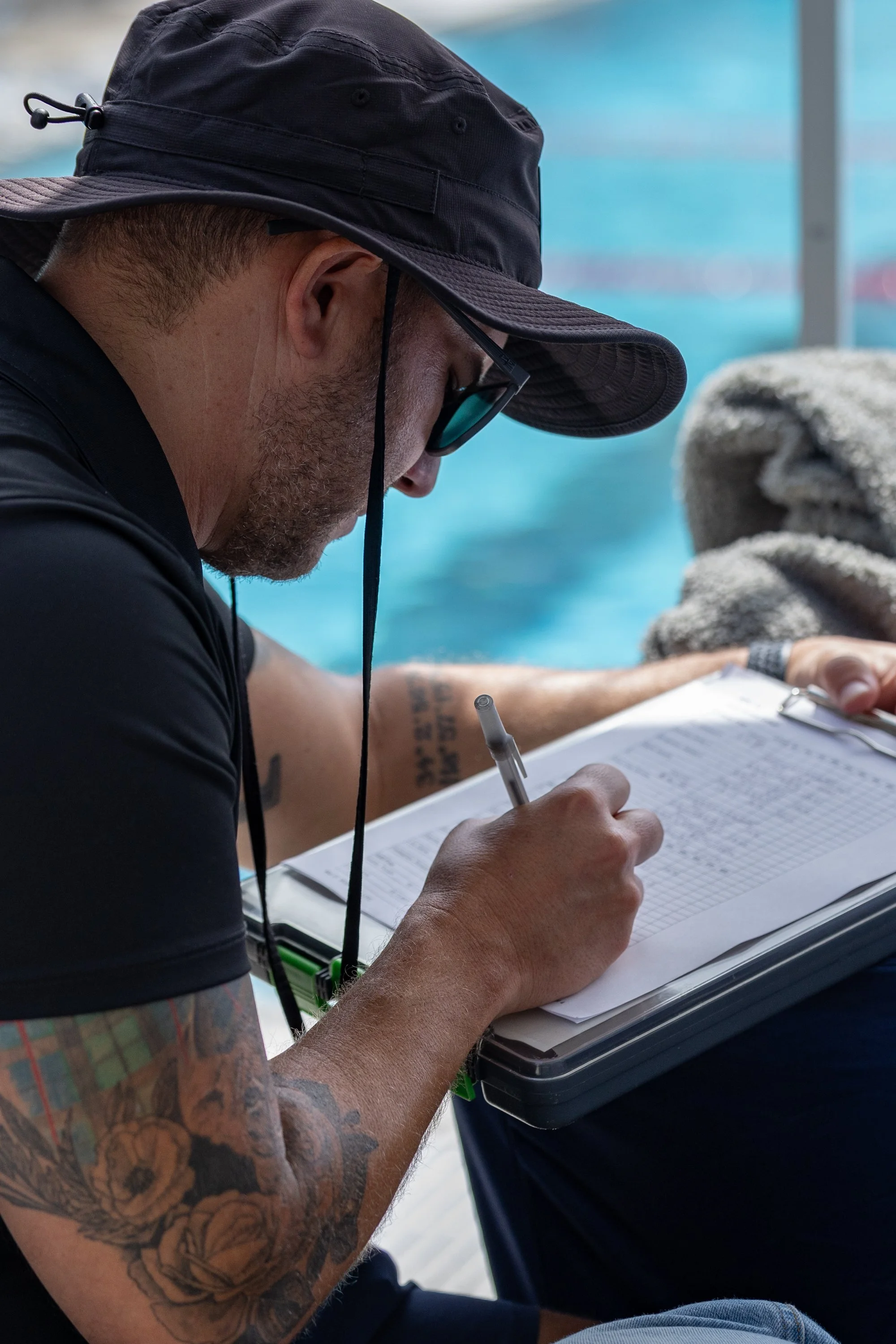  Santa Monica College (SMC) Swimming Head Coach Brian Eskridge writes down the finishing times for the Women and Men Corsairs during the Western State Conference (WSC) #3  Swimming and Diving Meet on Friday, March 27, 2026, at the SMC Pool in Santa M
