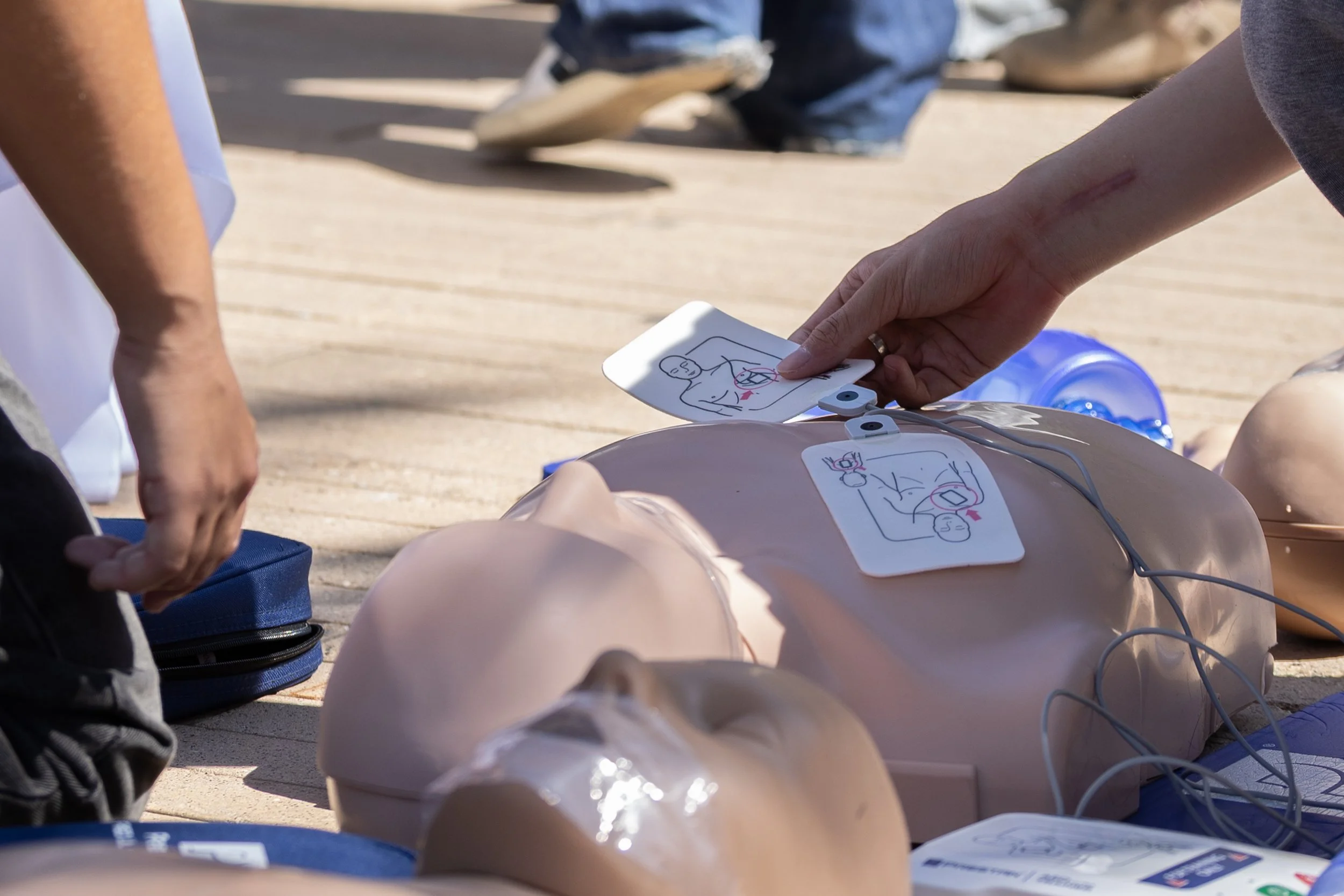  Thomas Lu, an accounting major, applies pads of an Automated External Defibrillator at the Pre-Health Professional Association (PHPA) during the Santa Monica College (SMC) Club Awareness event on the Quad of the SMC Main Campus in Santa Monica, Cali