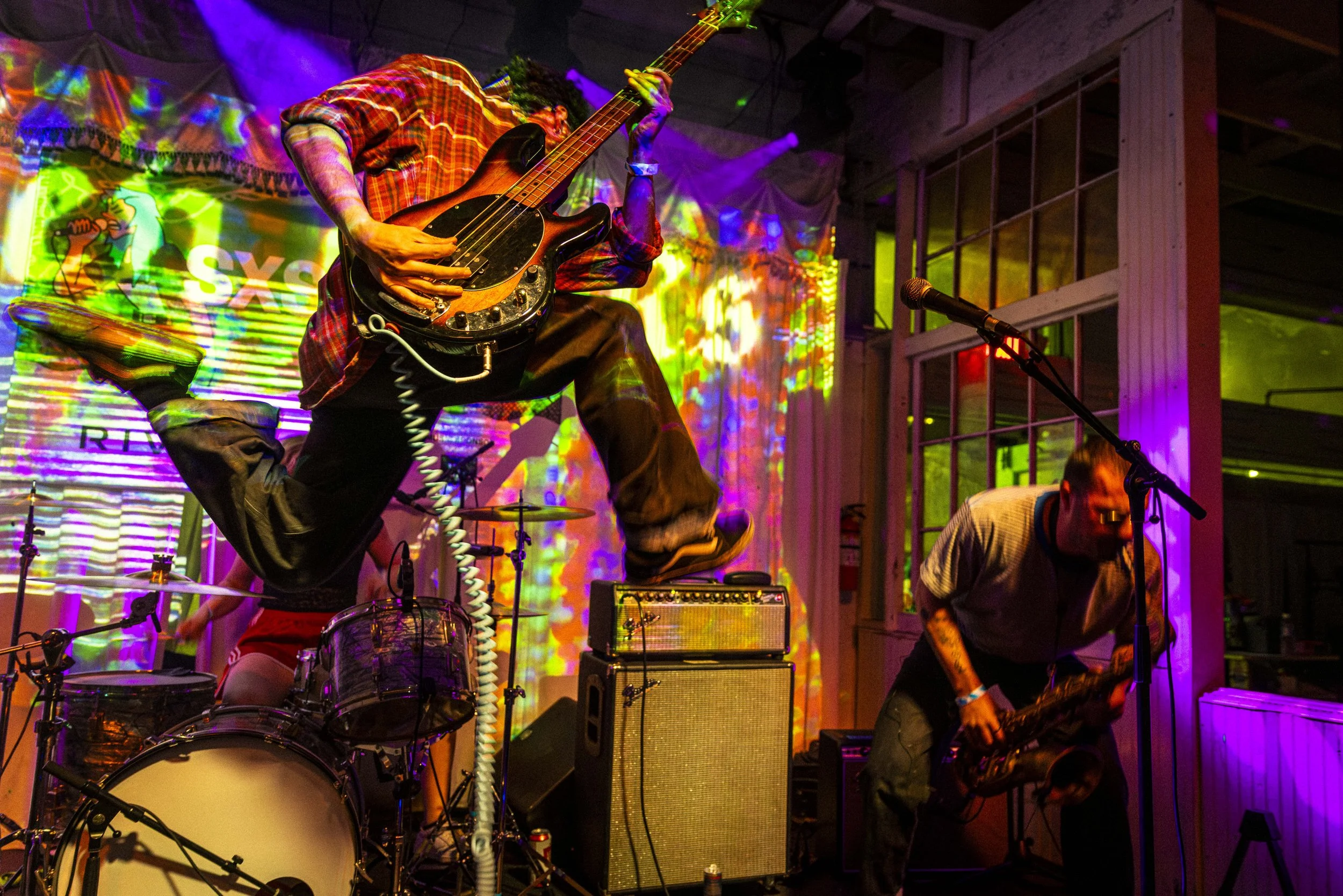  Stefan Parker-Steele of London’s post-punk trio, Alien Chicks, jumps mid-air while performing at Swan Dive on Monday, March 16, 2026, in Austin, Texas, during the South by Southwest (SXSW) festival. Although SXSW celebrated its 40th edition this yea
