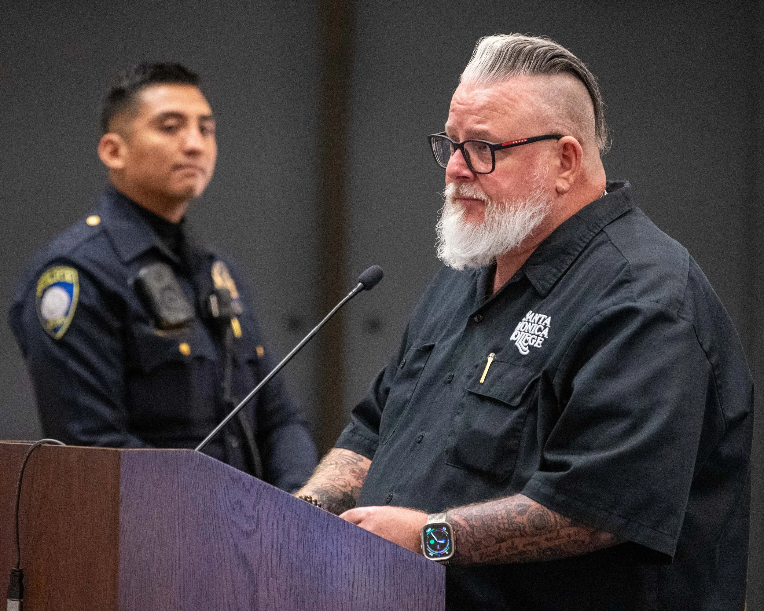  Santa Monica College (SMC) Vice President of Business and Administration, Chris Bonvenuto eulogizes the late SMC Police Captain Jere Romano during the public comment portion of the Board of Trustees meeting held in the Orientation Hall of the SMC St