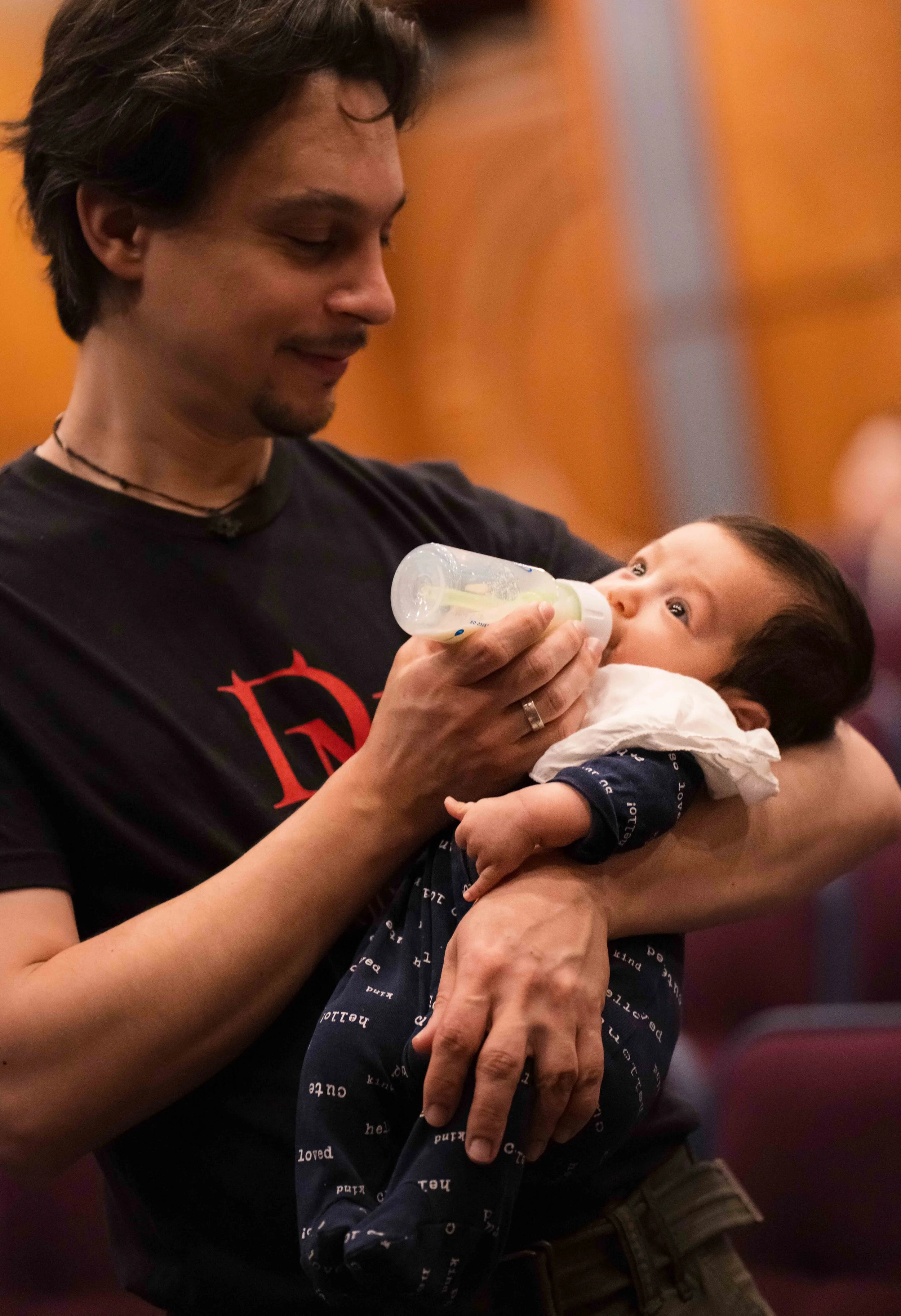  Etienne Gara feeds son Elian during a rehearsal break at Théâtre Raymond Kabbaz in Los Angeles, Wednesday, March 25, 2026. Elian was born in January, going on tour five weeks later with violinist parents Etienne Gara and YuEun Kim. (Elizabeth Bacher