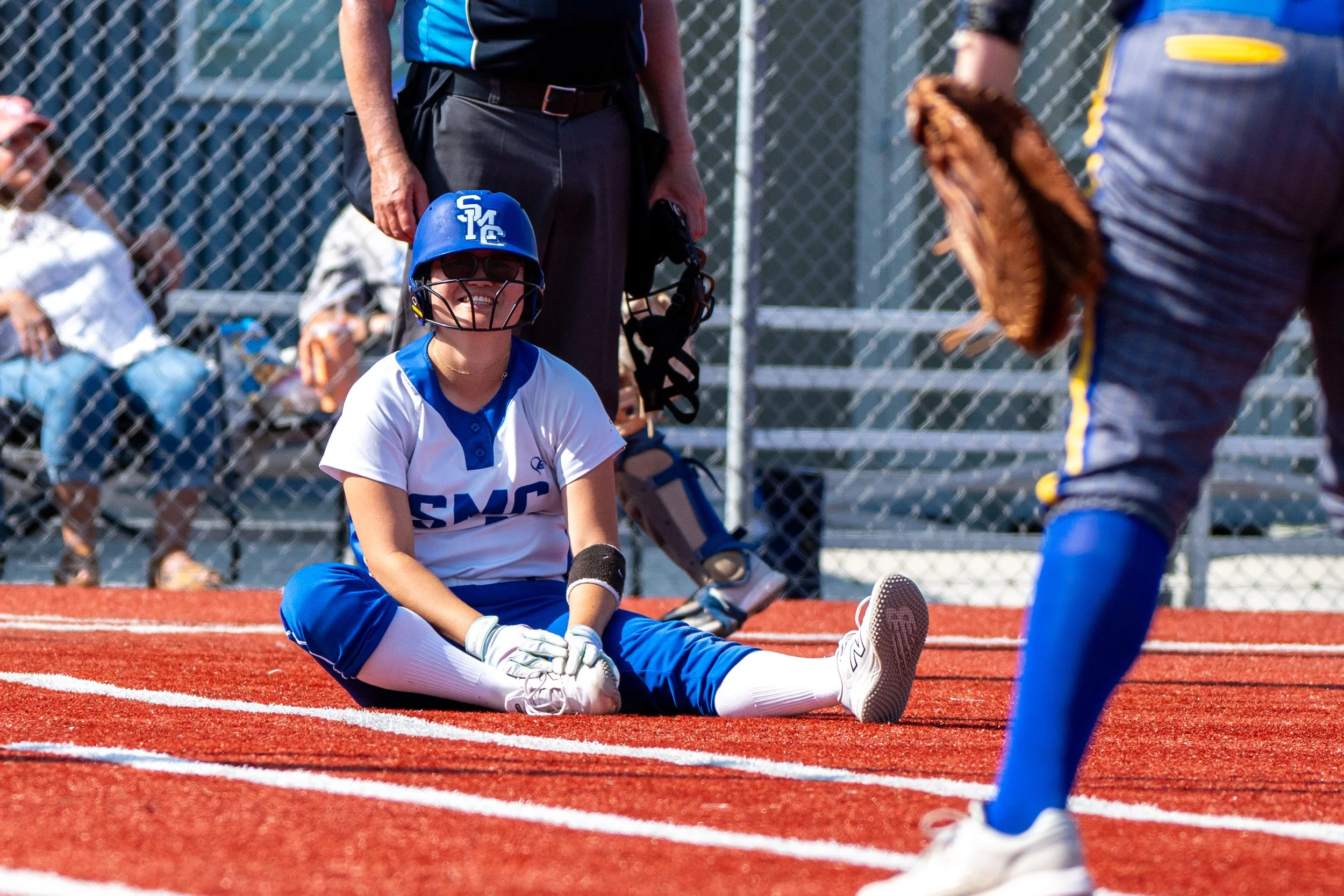  Santa Monica College (SMC) Corsair Mandi Yamada (30) laughs at tripping over the bat as she runs out of the batter's box in the game with Allan Hancock Bulldogs at Santa Monica, Calif., Tuesday, March 24, 2026. The Corsairs were defeated by the Bull