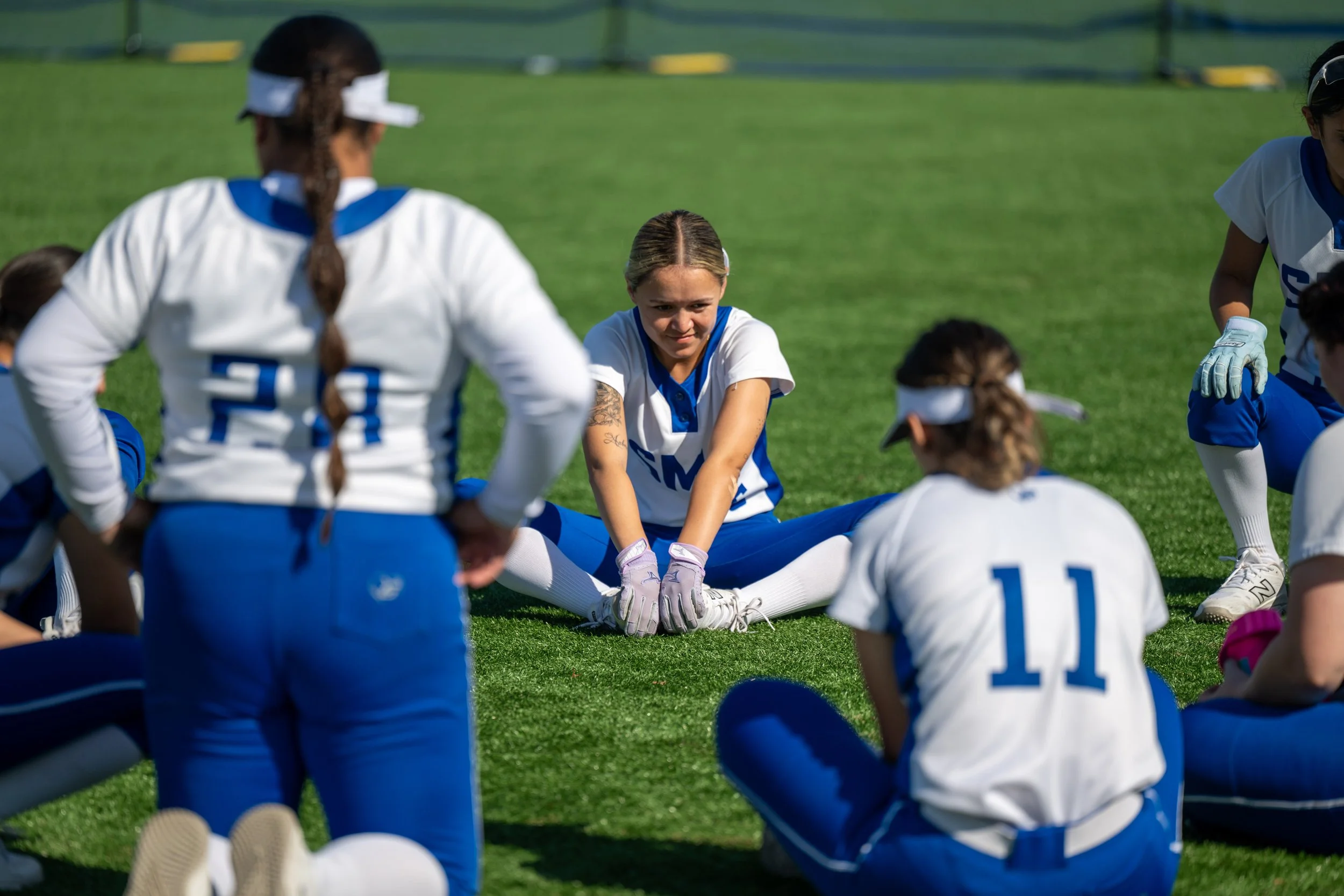  Santa Monica College Corsair Danaly Santos (12) stretching with team after the game against Moorpark College Raiders in Santa Monica, Calif., on Friday, Feb. 27, 2026. The Corsairs were defeated by the Raiders 16-0. (Tom Rosholt | The Corsair) 