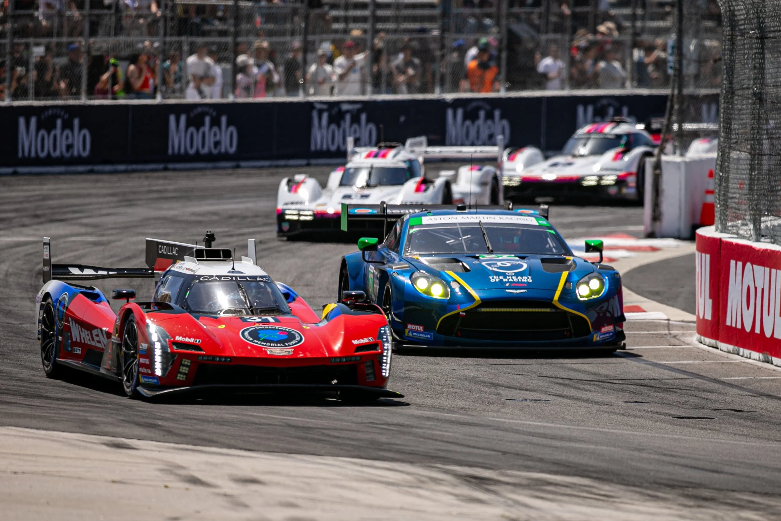  Grand Touring Prototype (GTP) Cadillac Whelen Cadillac V-Series.R number 31 driven by Jack Aitken (CQ) and Frederik Vesti (CQ) overtaking Grand Touring Daytona (GTD) Heart of Racing Team Aston Martin Vantage GT3 Evo number 27 driven by Dudu Barriche