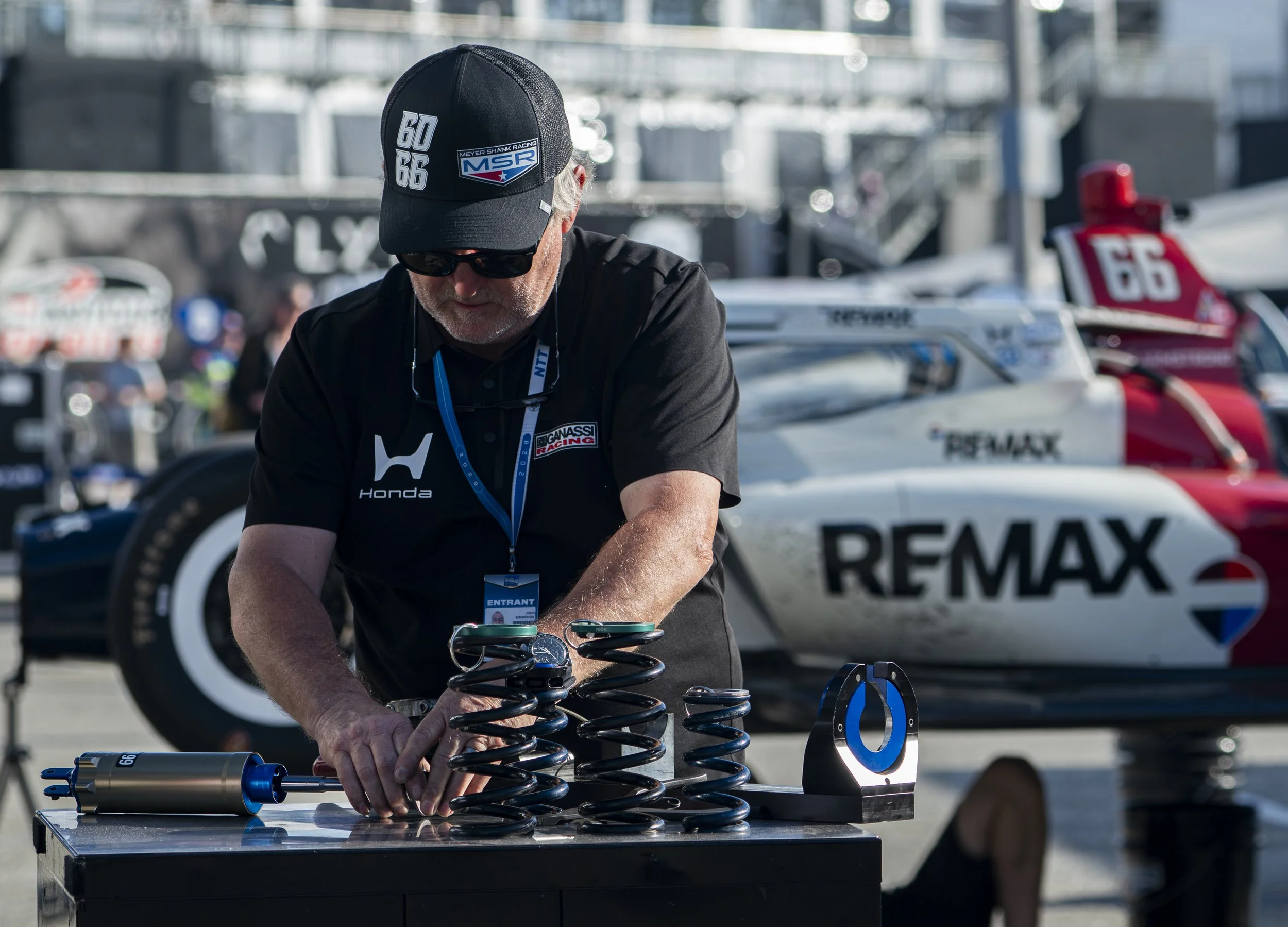  Nippon Telegraph and Telephoneplasce (NTT) Indycar Series team Meyer Shank w/ Curb-Agajanian crew members disassemble suspension on Marcus Armstrong's (No. 19) Dallara DW12 in the team Paddock area after the final race of the 2026 Acura Grand Prix o