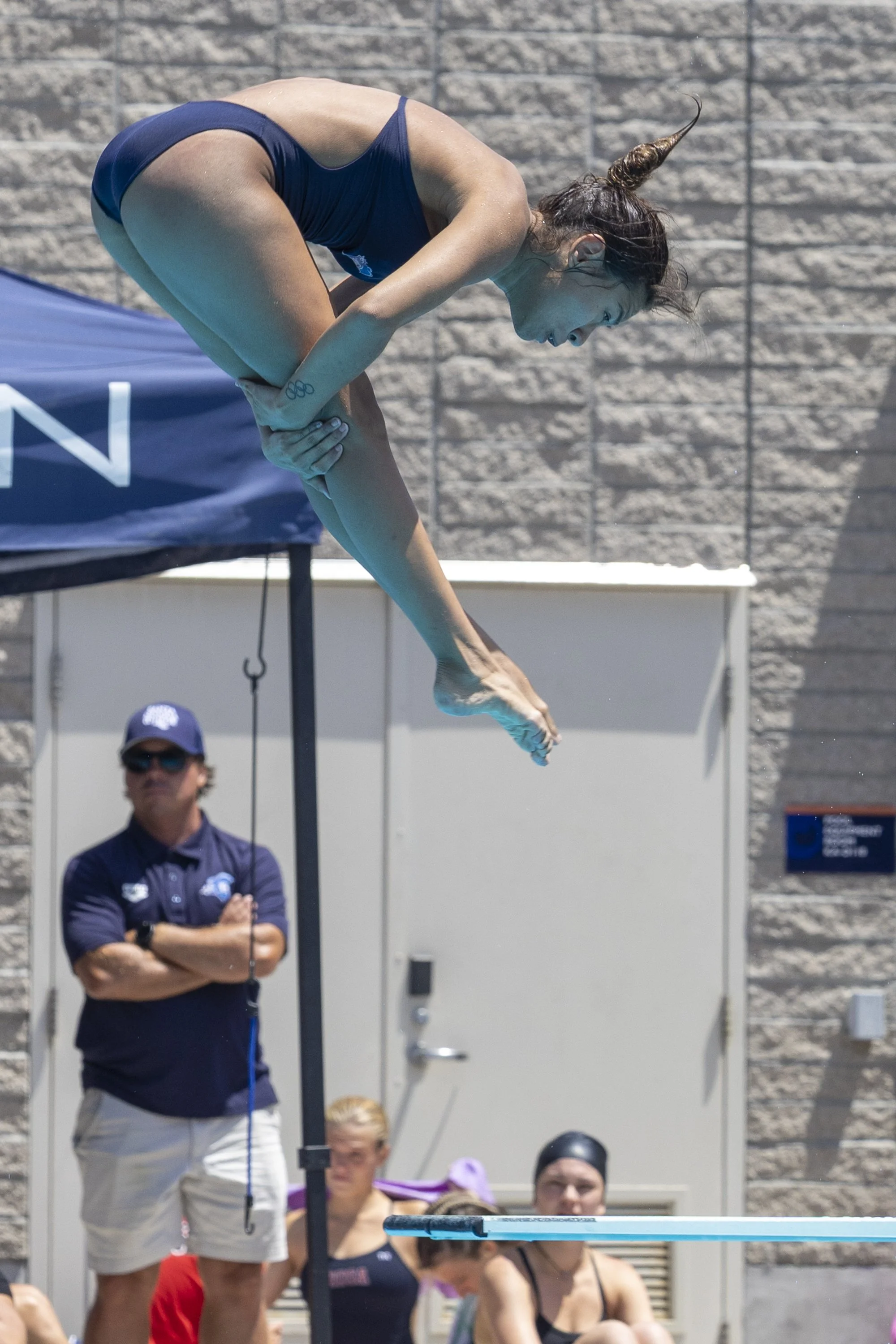  Karla Perez, Santa Monica College Diving Corsair and a 2018 Youth Olympics Gymnast, dives from the one-meter board with observation by head coach Ryan King at the 3C2A State Championship on Thursday, April 30, 2026, at the Orange Coast College Pool 