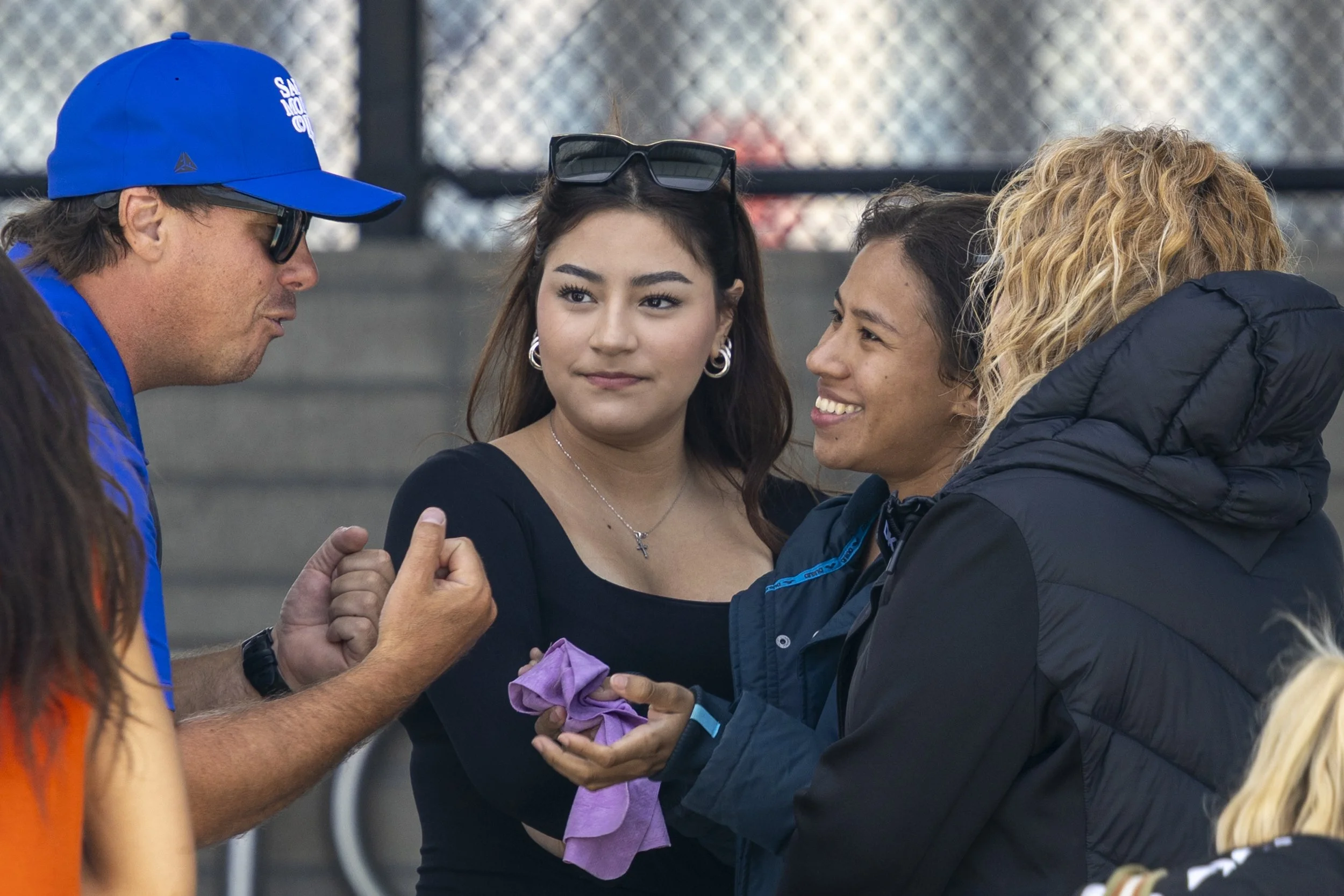  (L-R) Head coach Ryan King talks in front of Jimena Perez with Karla Perez, Santa Monica College Diving Corsair and a 2018 Youth Olympics Gymnast, and her mom, Arelis Blanco after  the three-meter board finals at the 3C2A State Championship on Frida