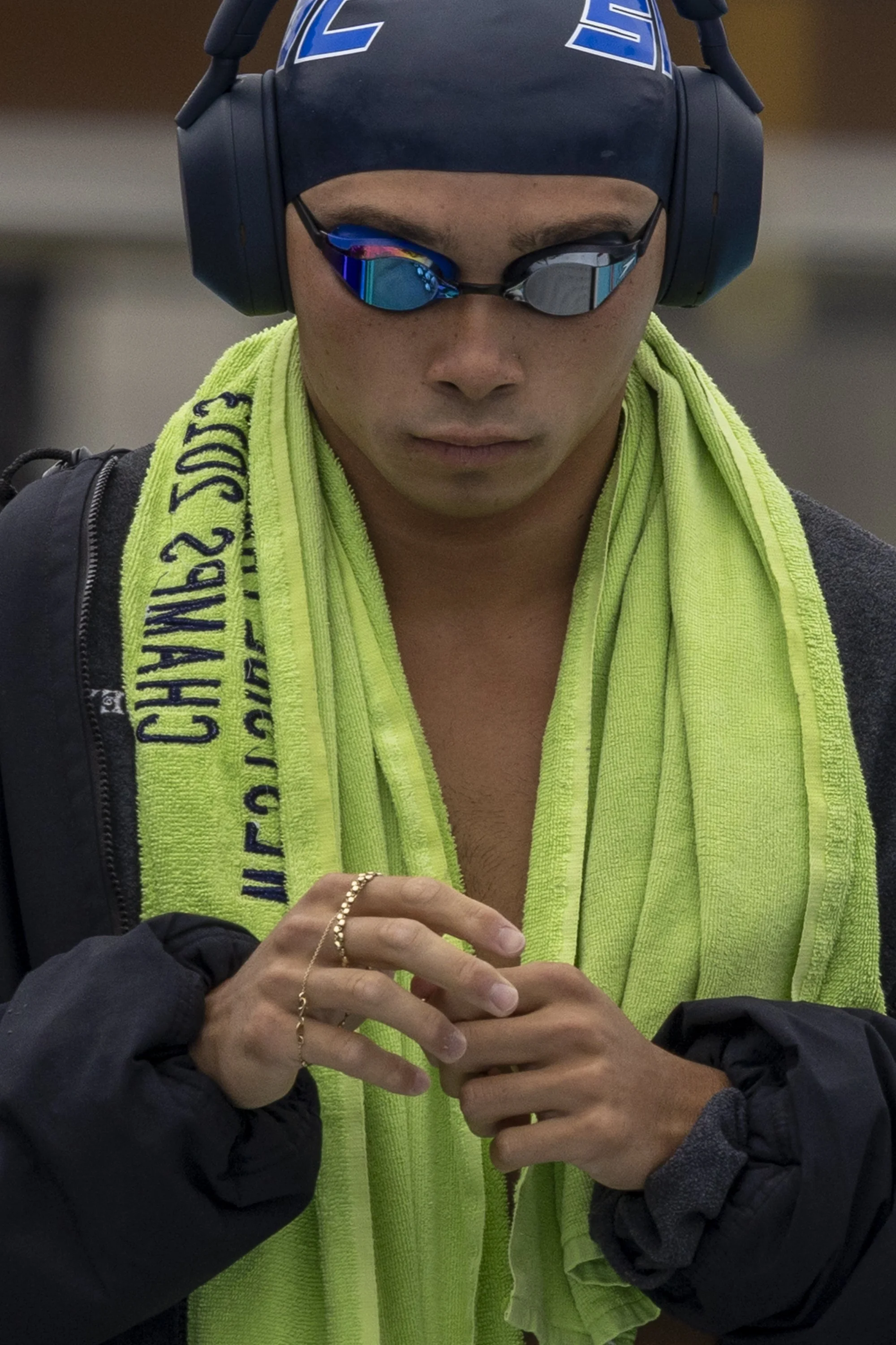  Riley Taizo Amis, Santa Monica College (SMC) Corsair, prepares himself for the Prelims of the men’s 100m breaststroke listening to music and holding a rosary during the 3C2A State Championship on Friday, May 1, 2026, at the Orange Coast College Pool