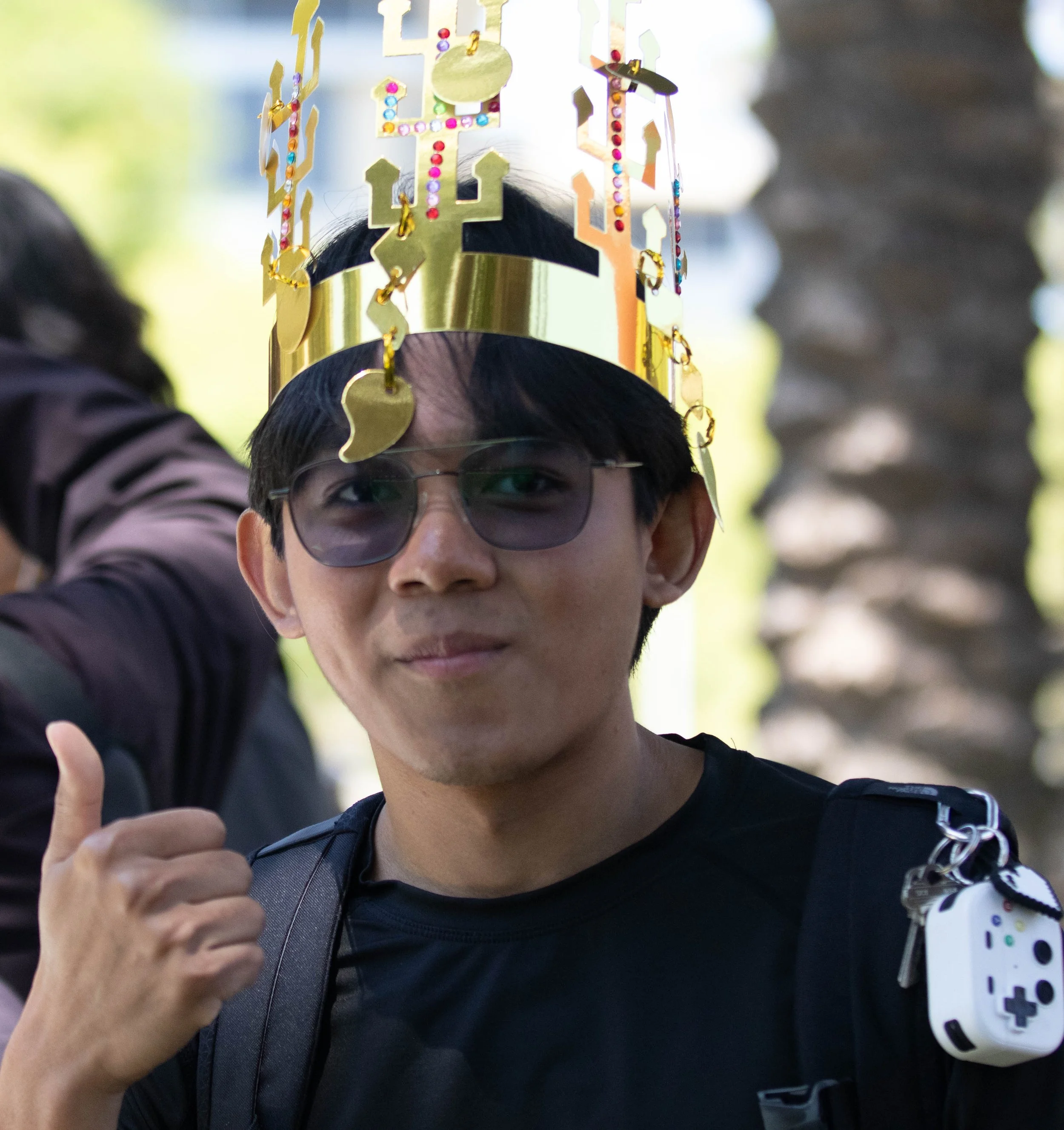  Santa Monica College (SMC) Computer Science major Thar Htet poses for a photograph wearing a crown he just made for himself at the Korean Student Association (KSA) table at the SMC Sustainability Fest on Thurs. April 23, 2026 at the SMC Quad on the 