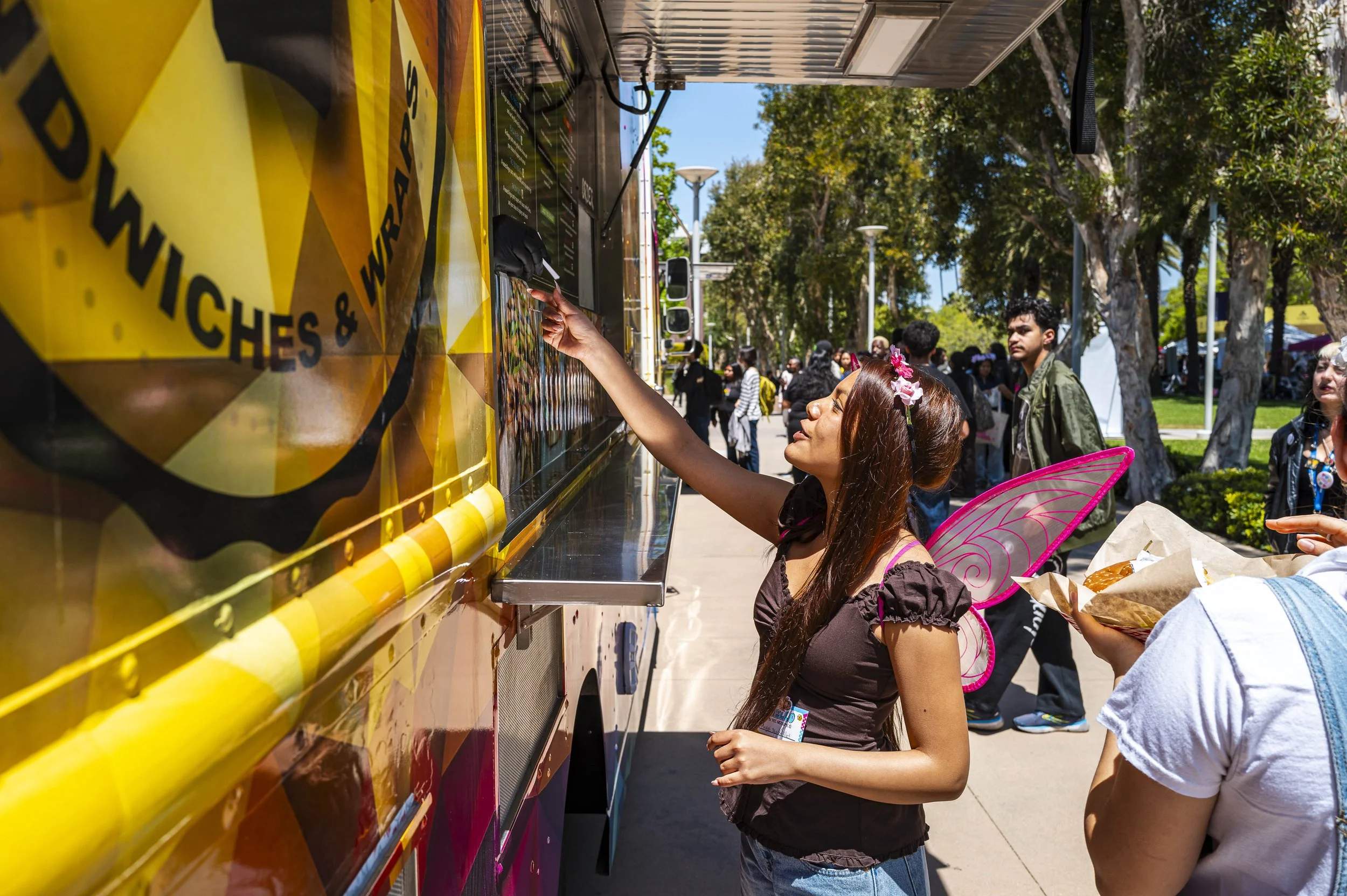  A Santa Monica College (SMC) student exchanges a meal ticket at a food truck during Club Row on Thursday, May 7, 2026, at the SMC Main Campus Quad in Santa Monica, Calif. Meal tickets were provided by the Associated Students of SMC during the event.