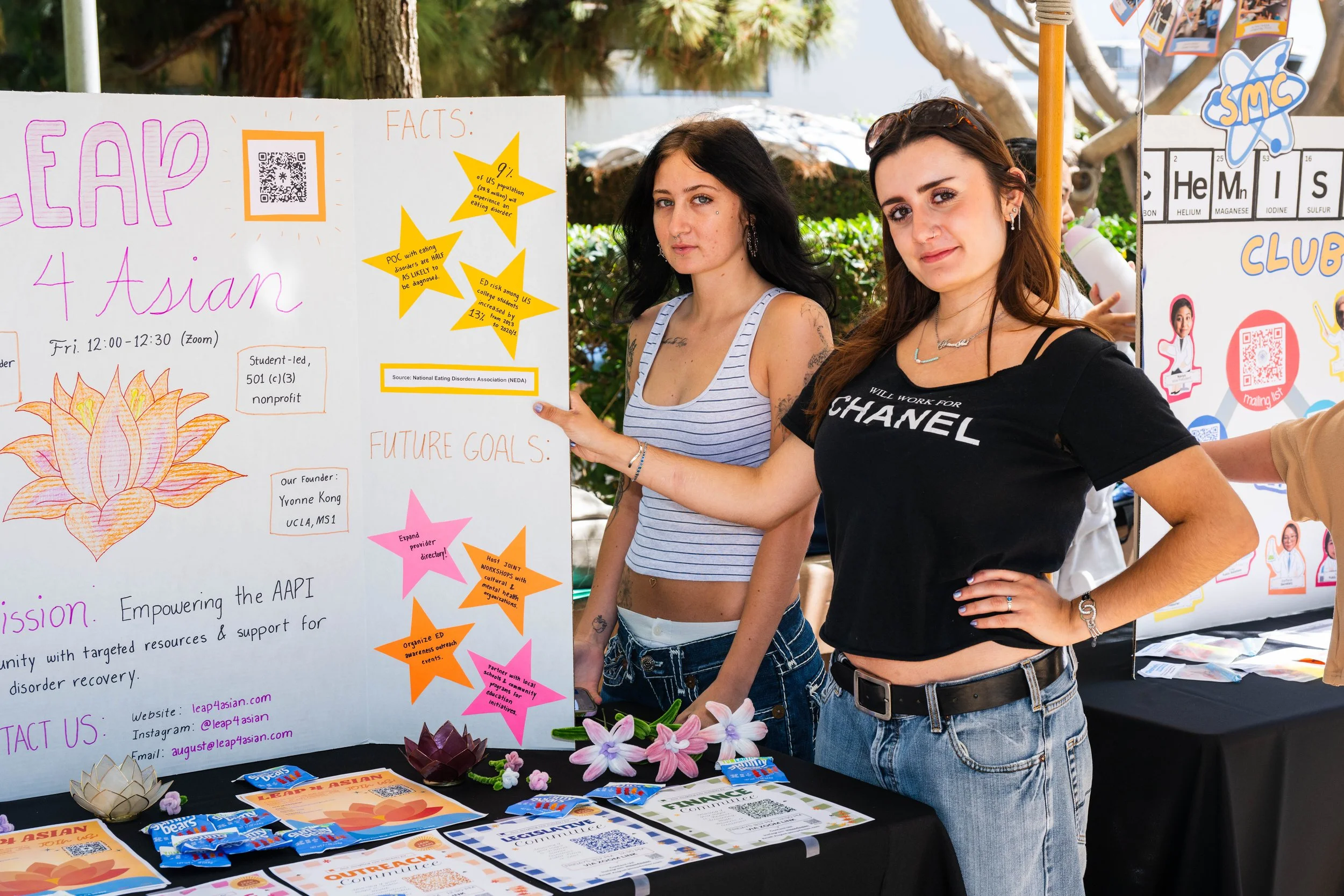  Santa Monica College students Lisa Kinsey (L), a public health major, and Sophia Lowey (R), a director of marketing and early childhood development major, display a poster for Leap4asian.com at Club Row on Thursday, May 7, 2026, in Santa Monica, Cal