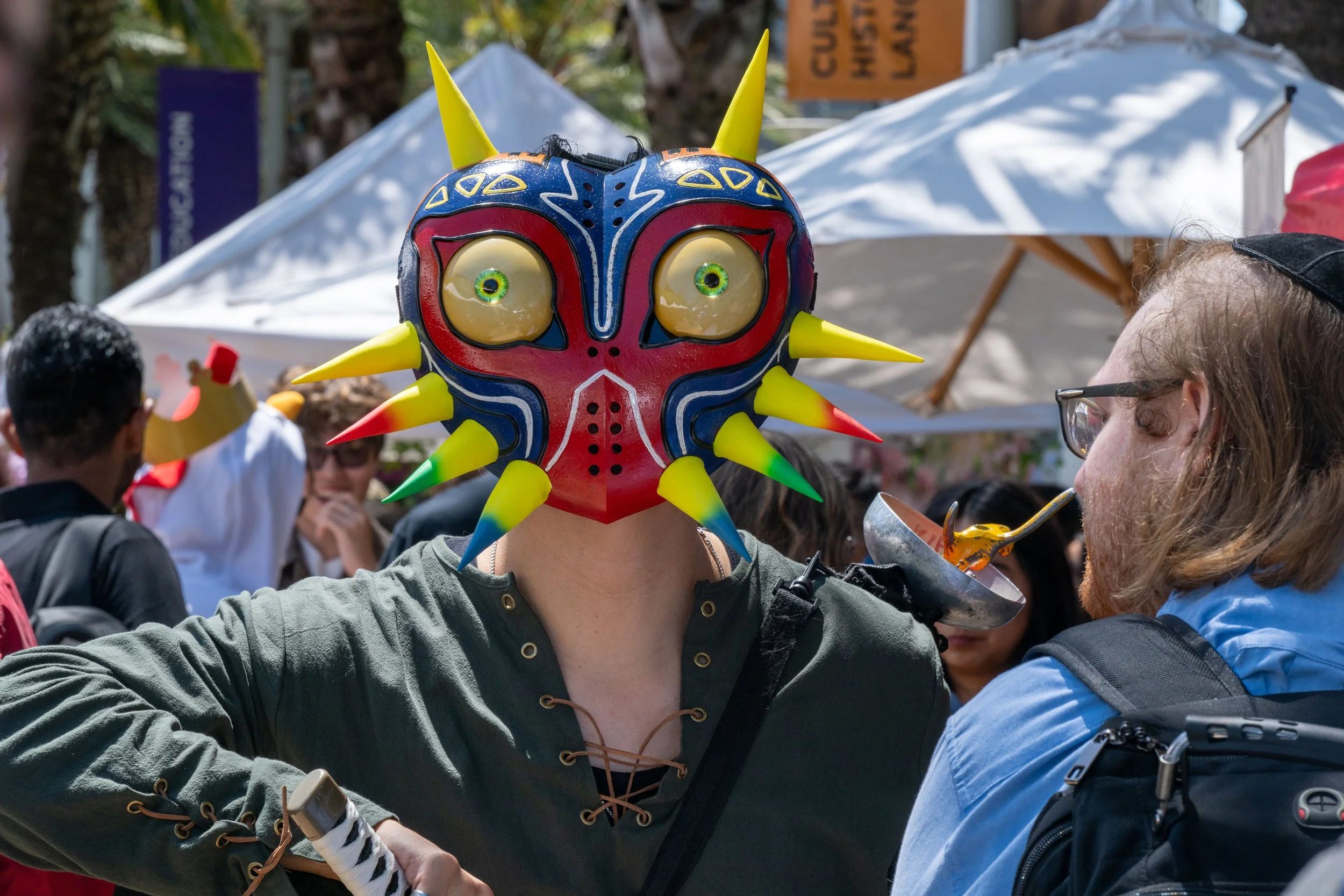  Santa Monica College student Jesse Guadron, a Game Design major, wears an alien mask while manning the booth for the Corsair Game Jams Club at Club Row on Thursday, May 7, 2026, in Santa Monica, Calif. (Tom Rosholt | The Corsair) 