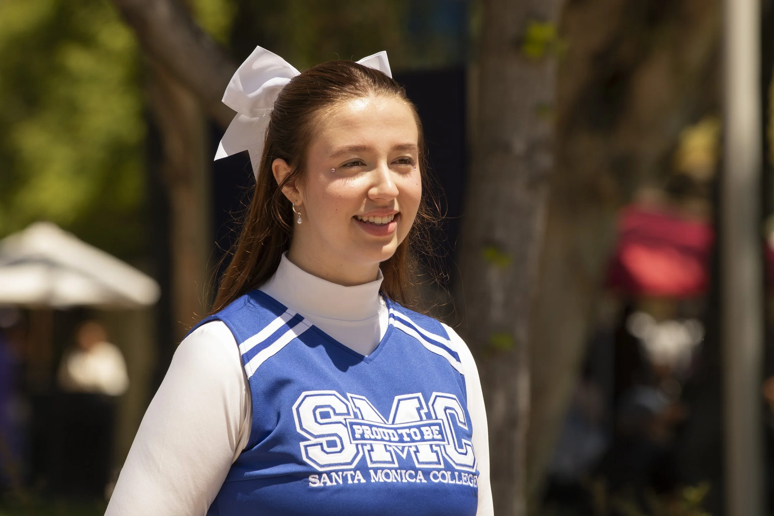  Amanda Bruers of the Santa Monica College (SMC) Cheer Club smiles for a video for Tik Tok at Club Row Day at the SMC main campus on Thursday, May 7th, 2026. The Cheer Club is “a diverse, social justice club whose mission is to spread school spirit a