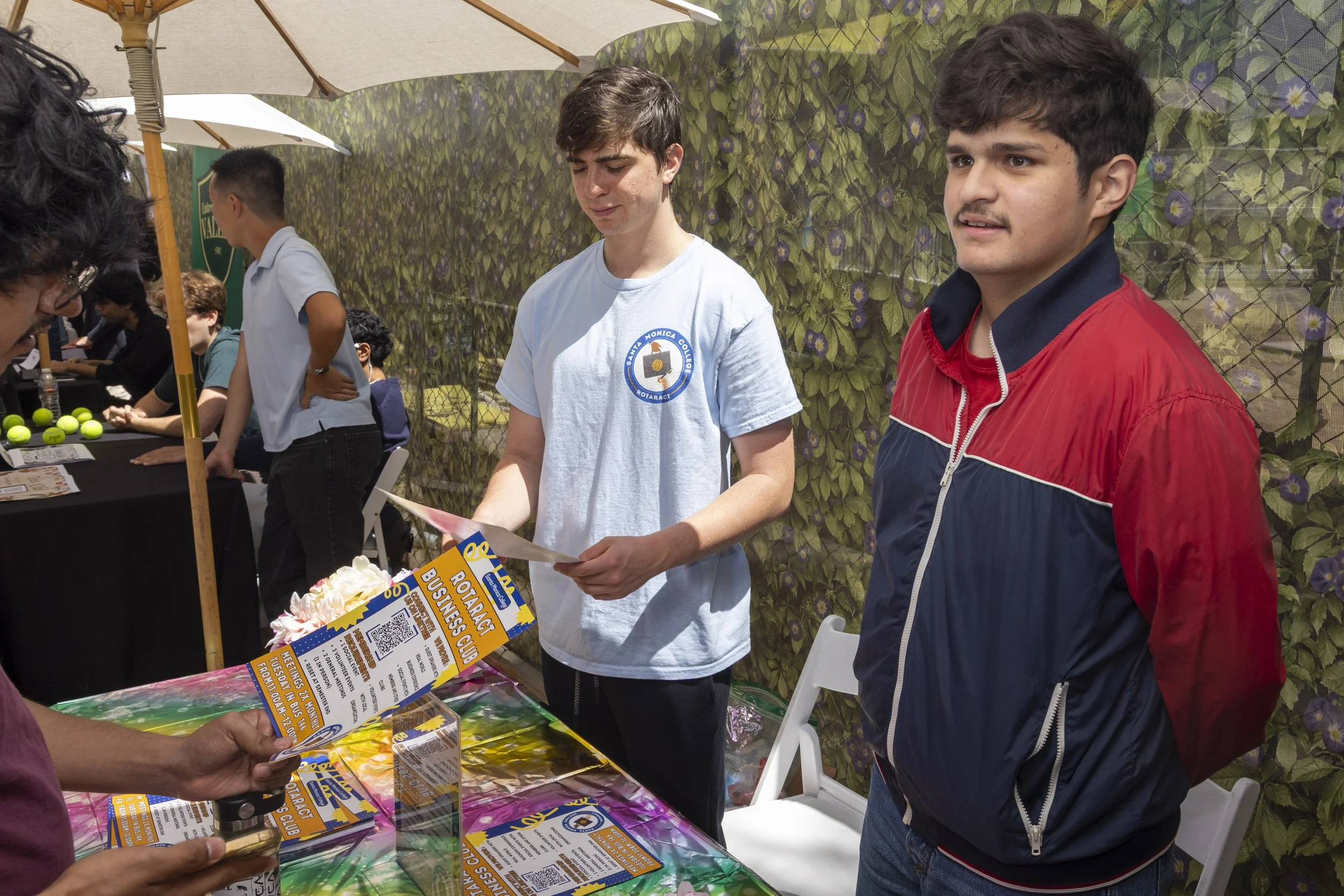  Gabriel Mivochnik (cq) and Emmanuel Sandoval (cq) (left to right) speak to an interested student about their club, the Rotaract Business Club, which offers networking opportunities with local businesses on the Santa Monica College campus, Thursday, 