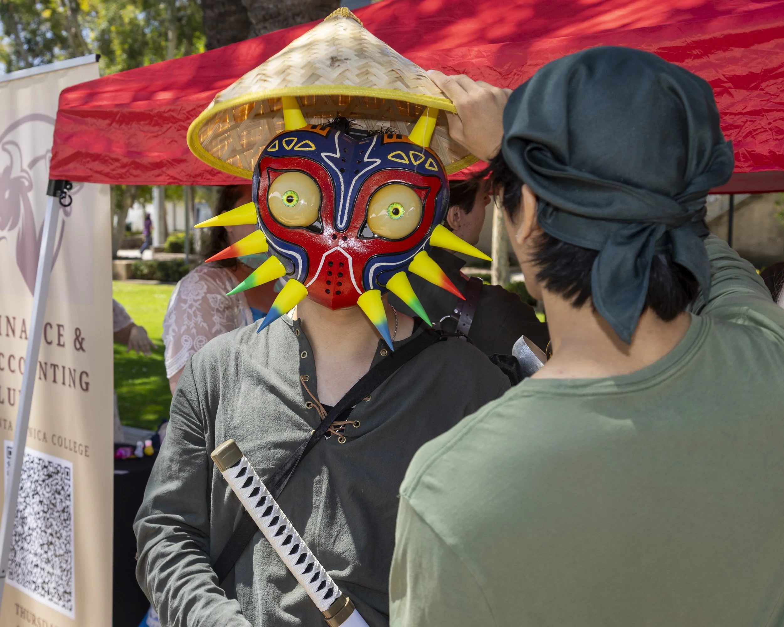  Jesse Guaroa (cq), vice president of the Corsair Game Jams club, poses outside their booth wearing a mask and holding a prop katana, on the Santa Monica College campus, Thursday, May 8, in Santa Monica, Calif., during the Club Row event. The club is