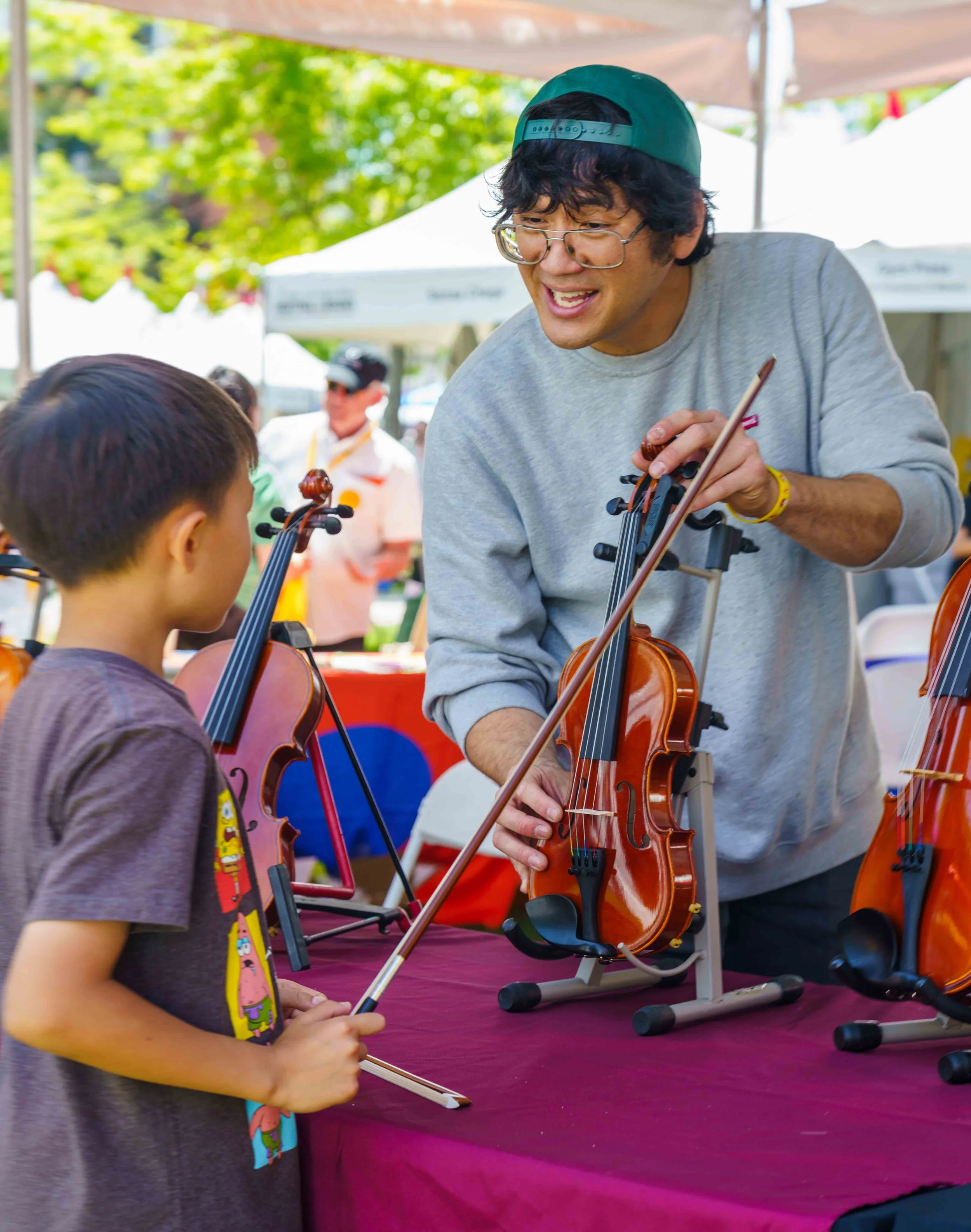  Violinist Wesley Wang (R) during a string instrument petting zoo from Metzler Violins, hosted by Classical California, during the Los Angeles Times Festival of Books held at University of Southern California in Los Angeles, Saturday, April 18, 2026.